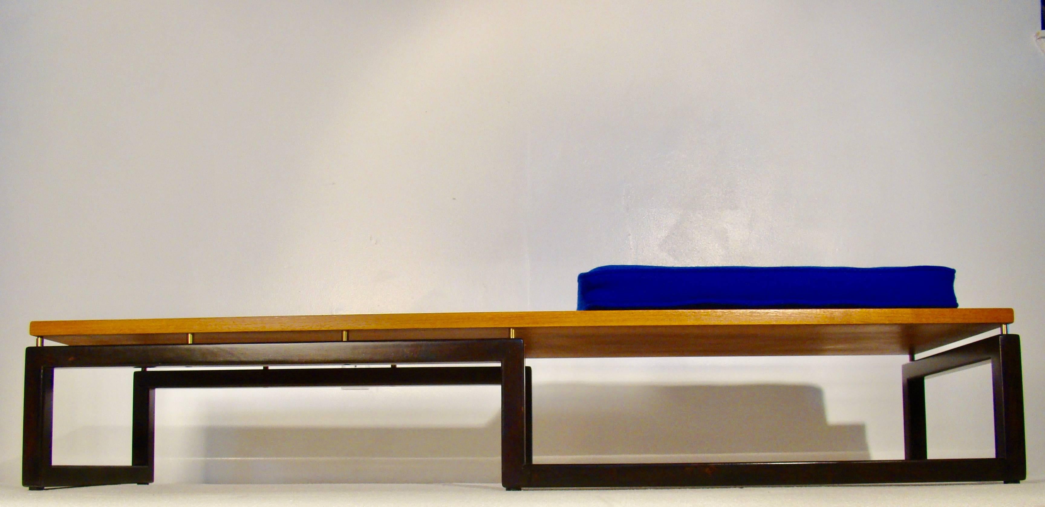 Sleek low geometric bench or coffee table by Michael Taylor for Baker Furniture. The top rests on raised brass dowels and can be used as a bench or coffee table. Retains the original brass baker tag on the underside. Has been completely restored.