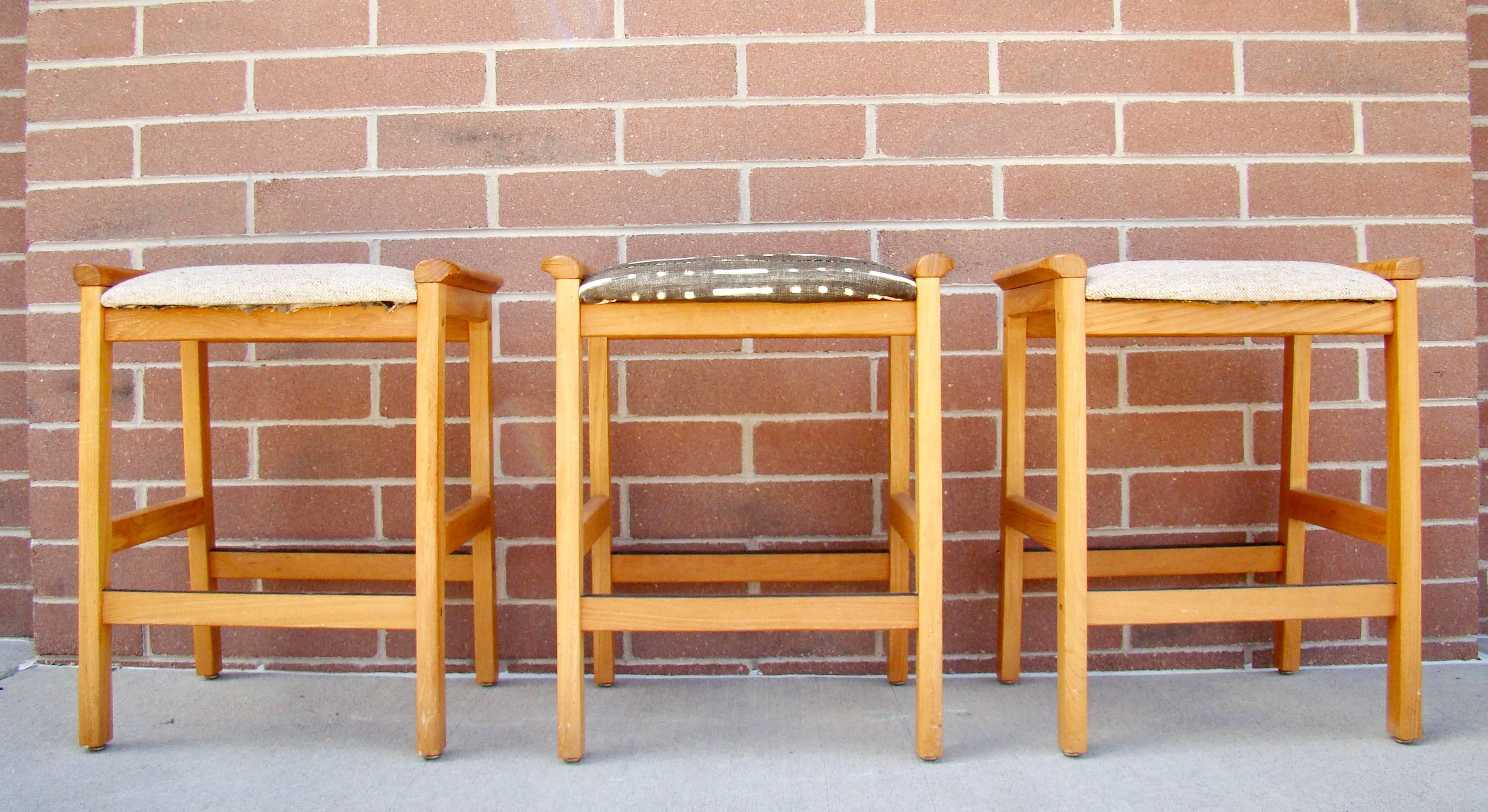 Counter height teak bar stools by J. L. Moller Hojbjerg Denmark. Marked with a paper label on the underside.