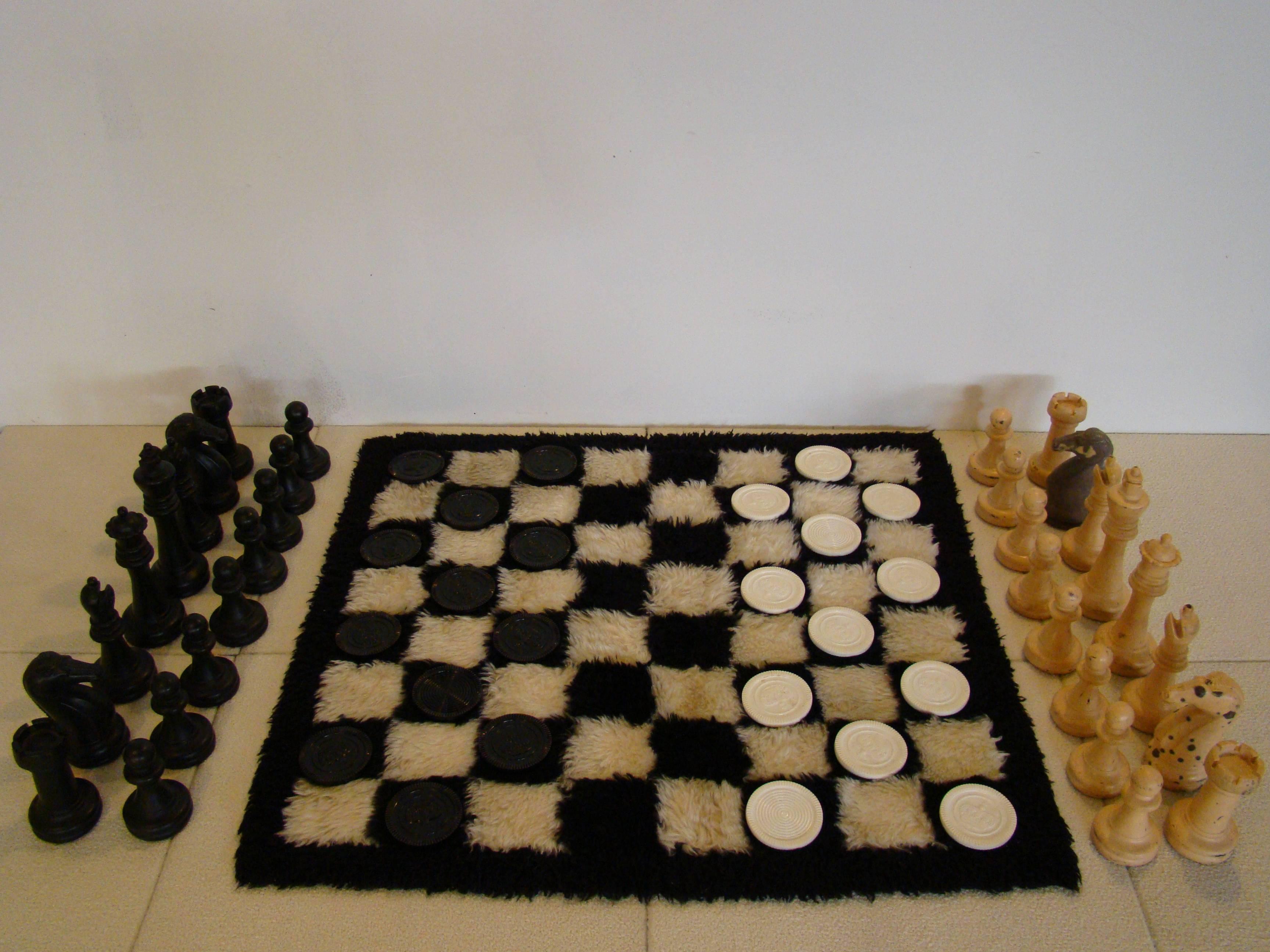 Fancy and fun chess/checkerboard with rug from the 1970s. Pieces are comprised of plastic. Rug is semi shag. Came from the original owner.