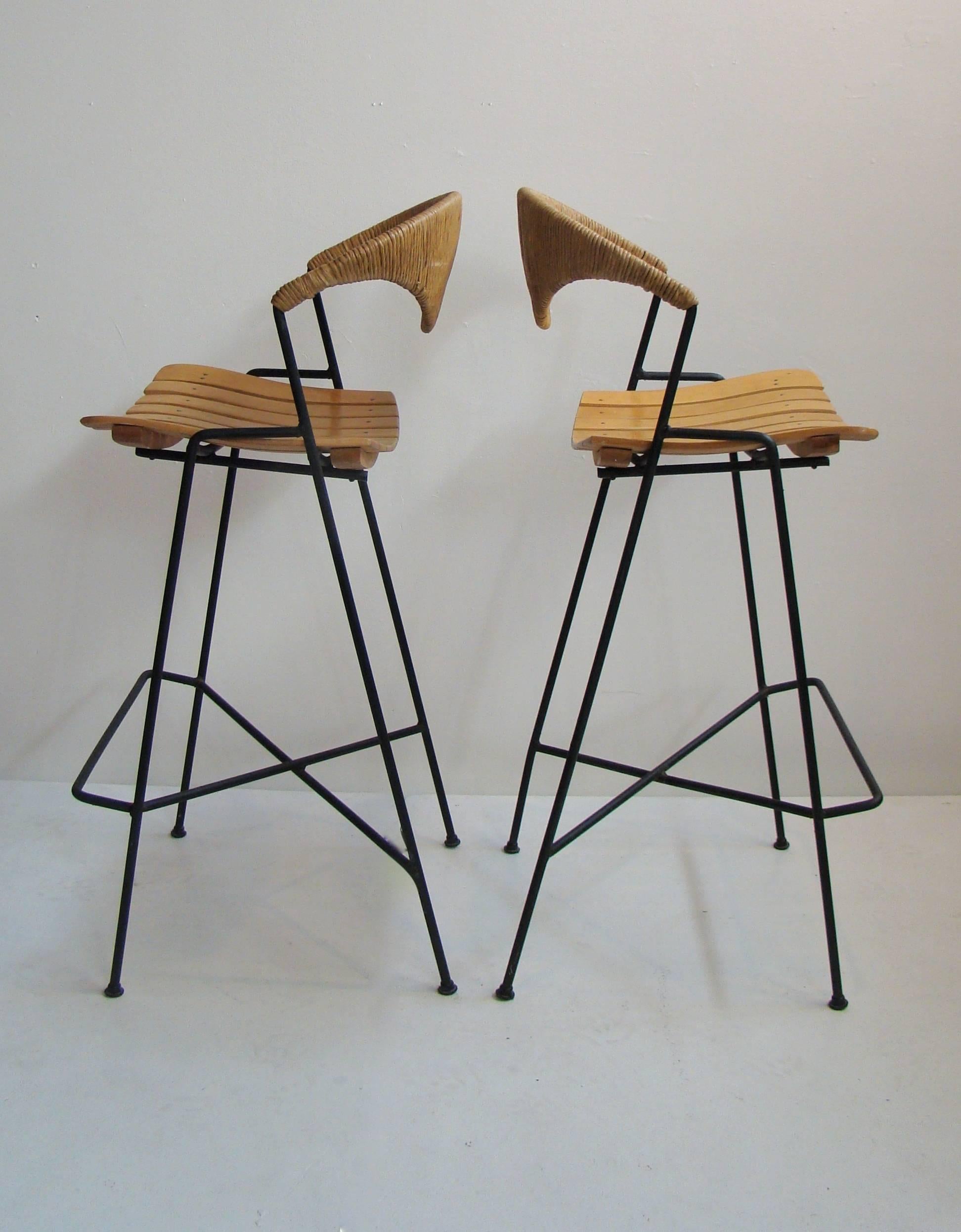 Beautiful set of 3 ....wrought iron and wood bar stools with matching bar designed by Arthur Umanoff for Raymor.  c.  1960s. All Pieces are  in very good original condition.  All glides present and no chips cracks or breaks.                    Bar