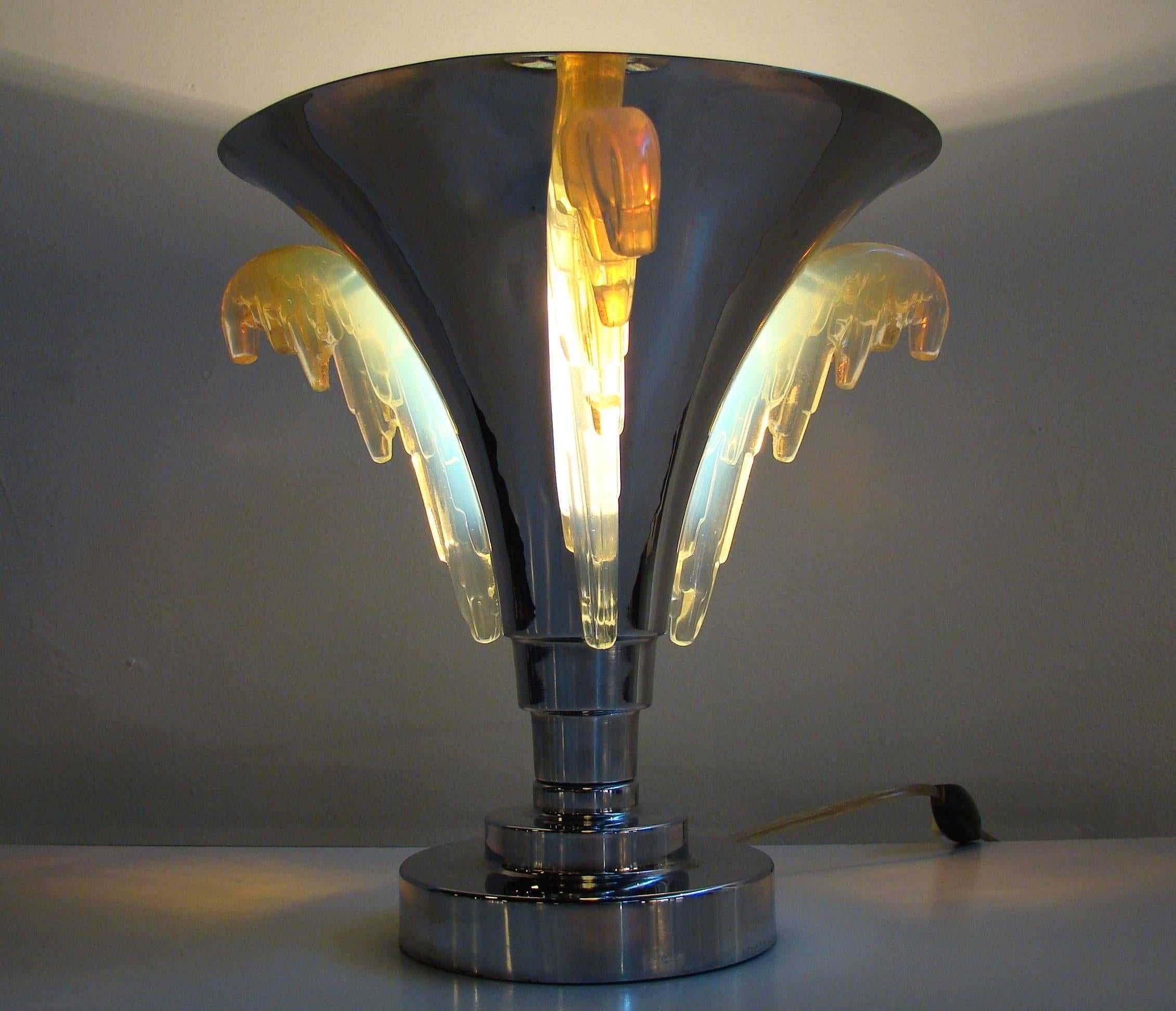 Exceptional French deco chrome torchiere with stepped base and translucent glass wings (probably Sabino glass). When illuminated, the lamp is exquisite. The glass piece that attaches to the inside of the lamp is stamped Melusine, Paris, France.