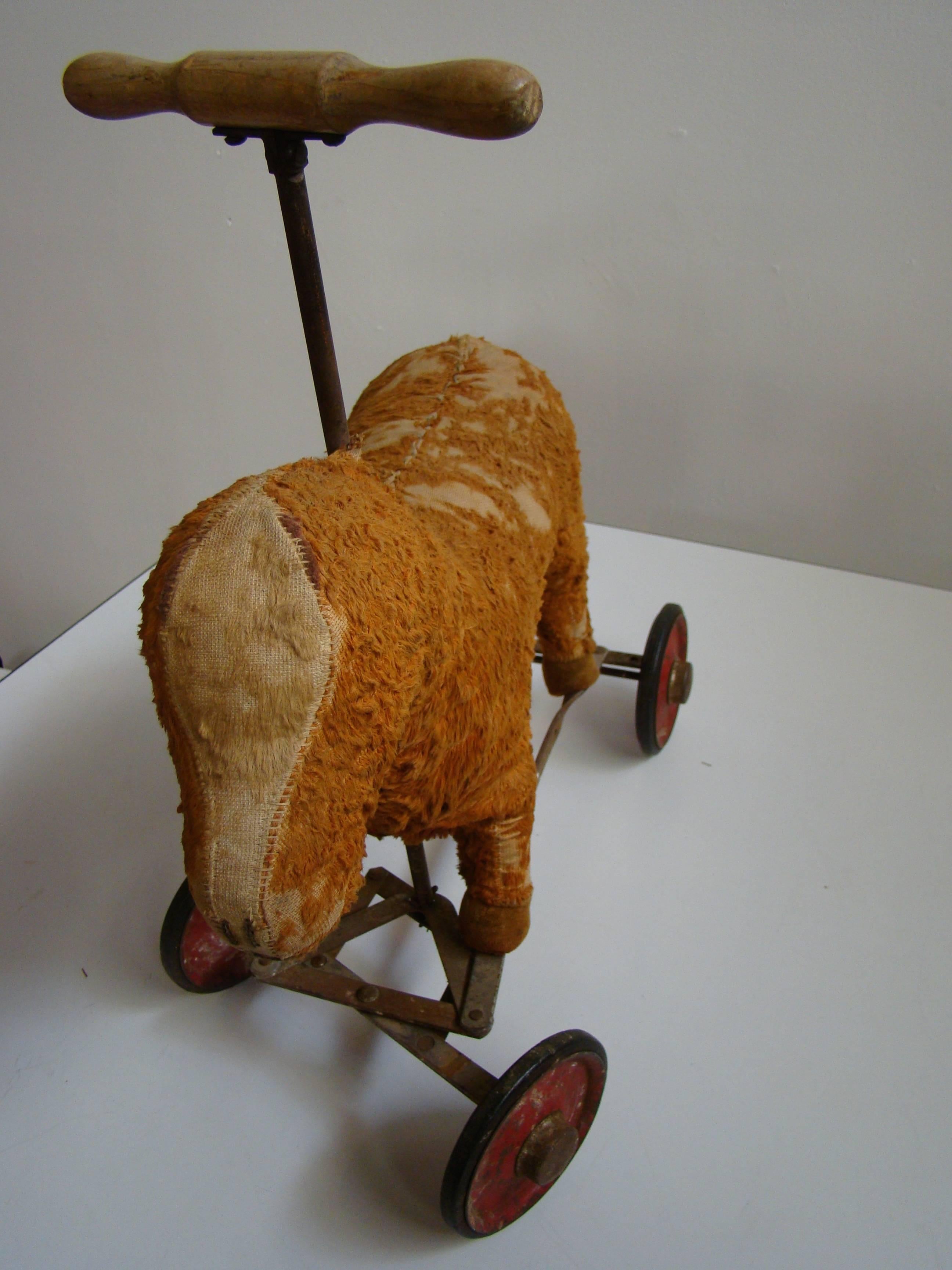 Wonderful early child's pull toy on wheels. Although this little guy has seen better days, he is still fully functional and the pull stick is intact. Bear on wheels shown in image 6 is listed separately.