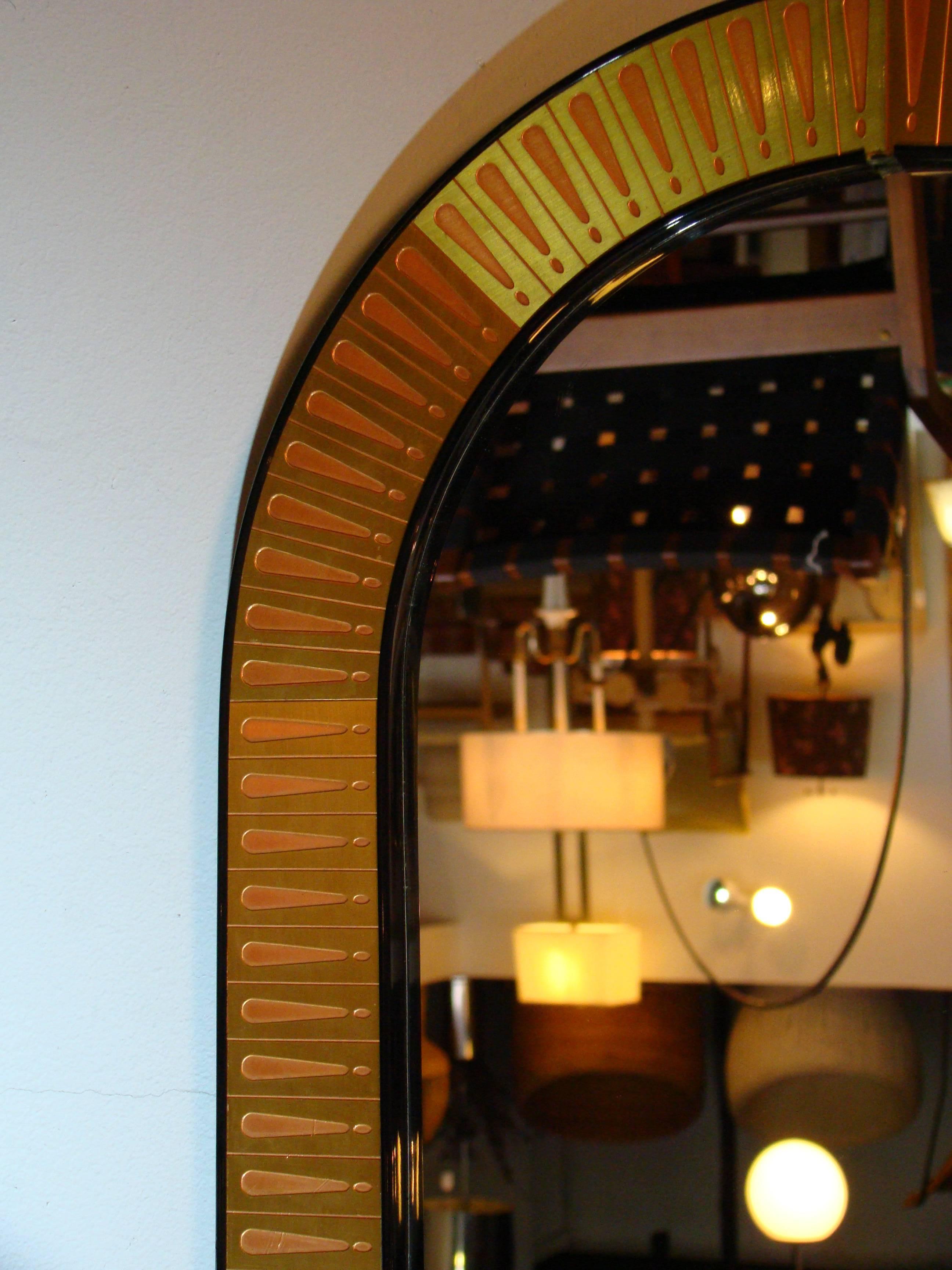 Brass and copper wall mirror by artist Bijan. Bijan is well-known for his 3D sculptures in bronze, copper and brass. This mirror, as all his pieces are, is individually handcrafted. A beautiful and unique mirror that will make a statement in any