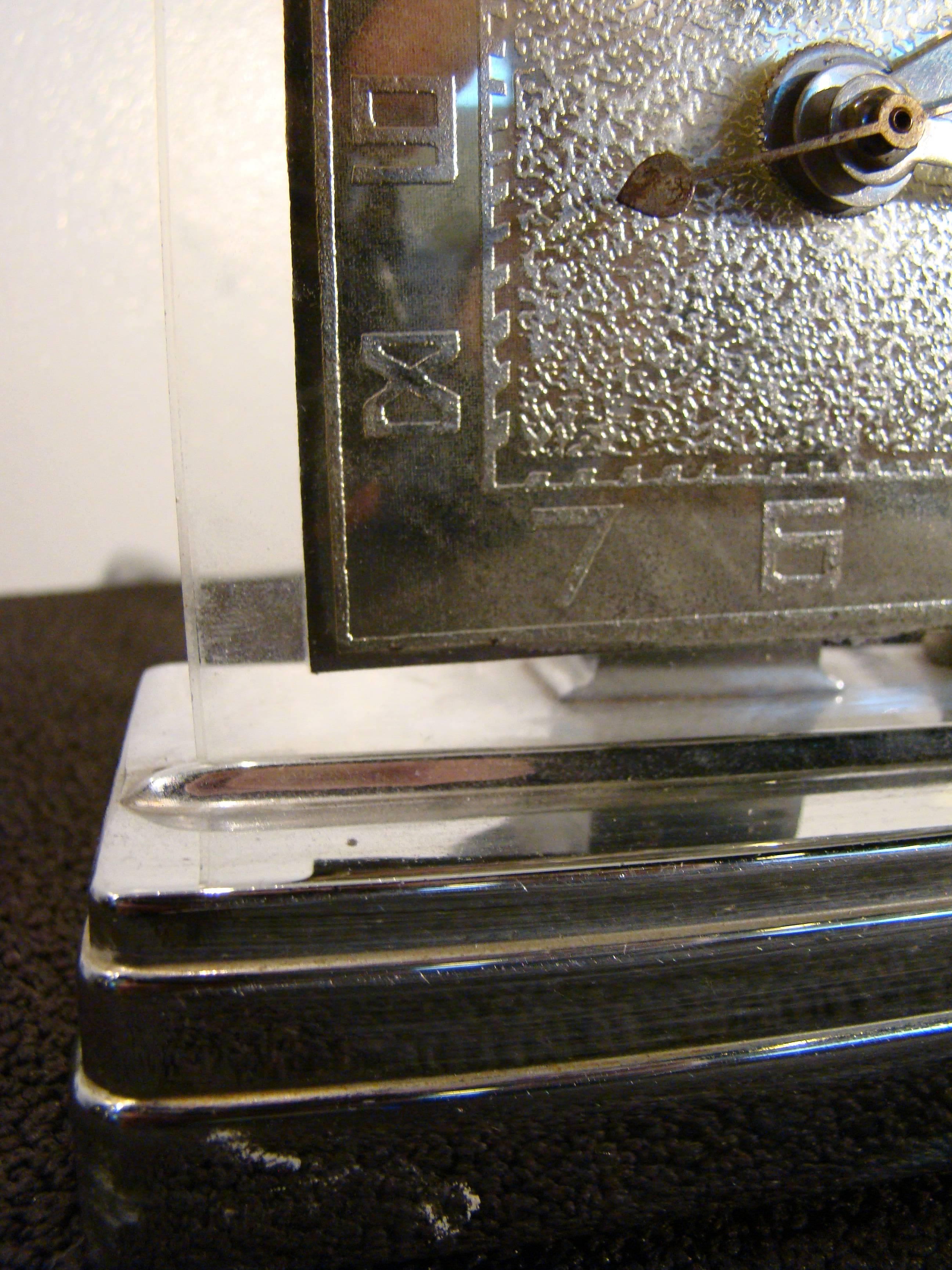 Viking moon glo electric lighted mantle clock, circa 1938. Sitting on a chrome stepped base, this clock was lit from below and when it hit the grainy surface in the middle, it was meant to resemble a full moon. Light is working presently. Clock is