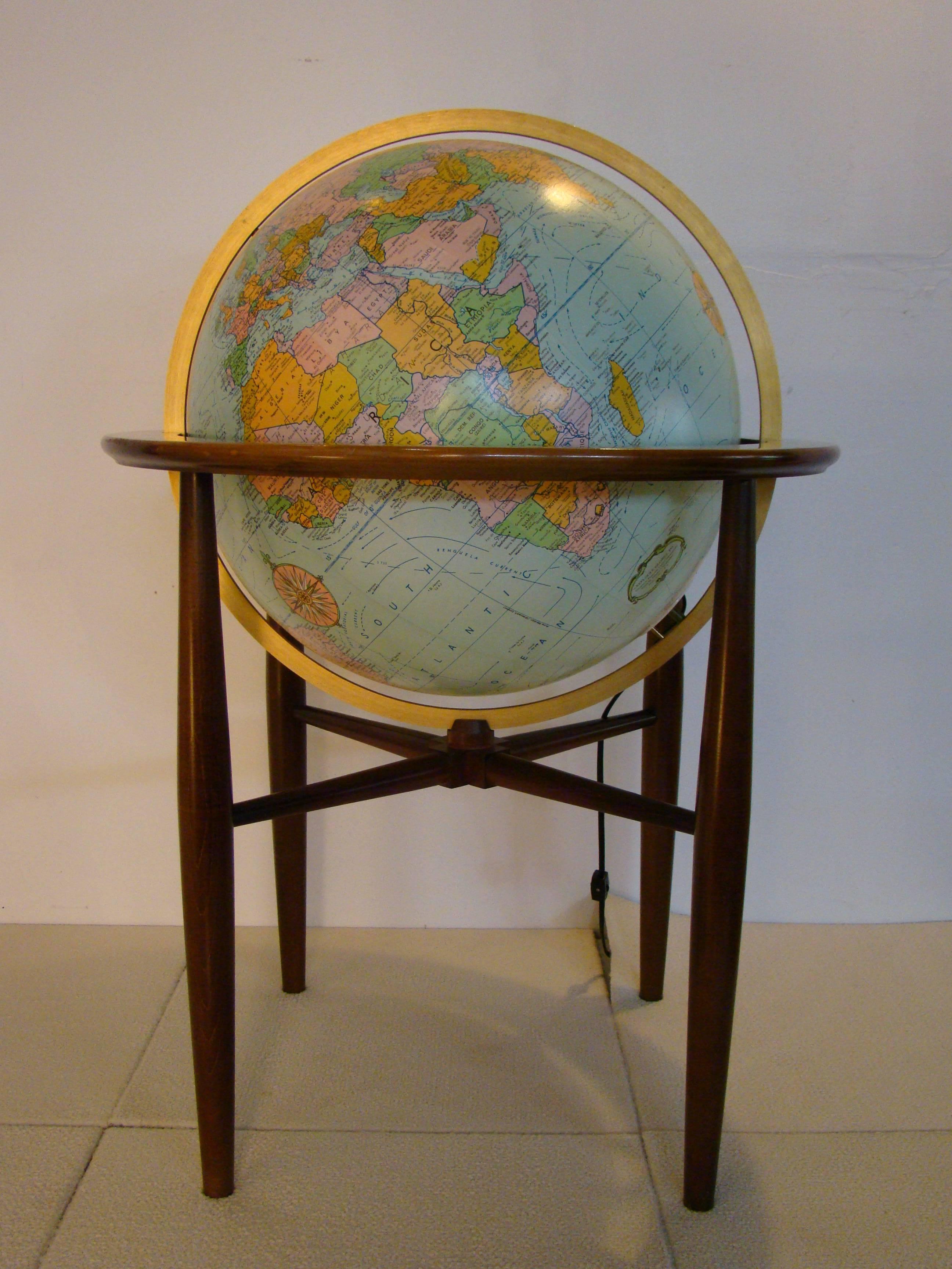 Stunning monumental illuminated world globe on walnut stand by Replogle, circa 1960s. Excellent for an additional light source.