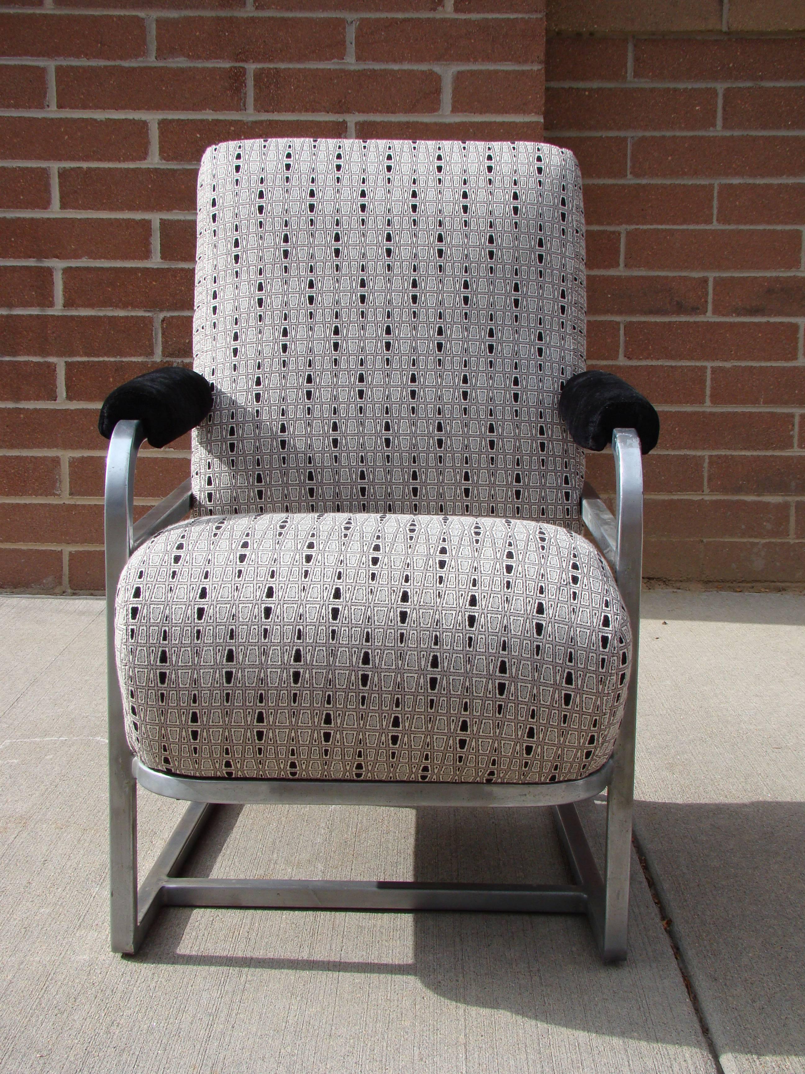 Art Deco Machine Age tubular aluminum railroad lounge chair. Has been reupholstered.