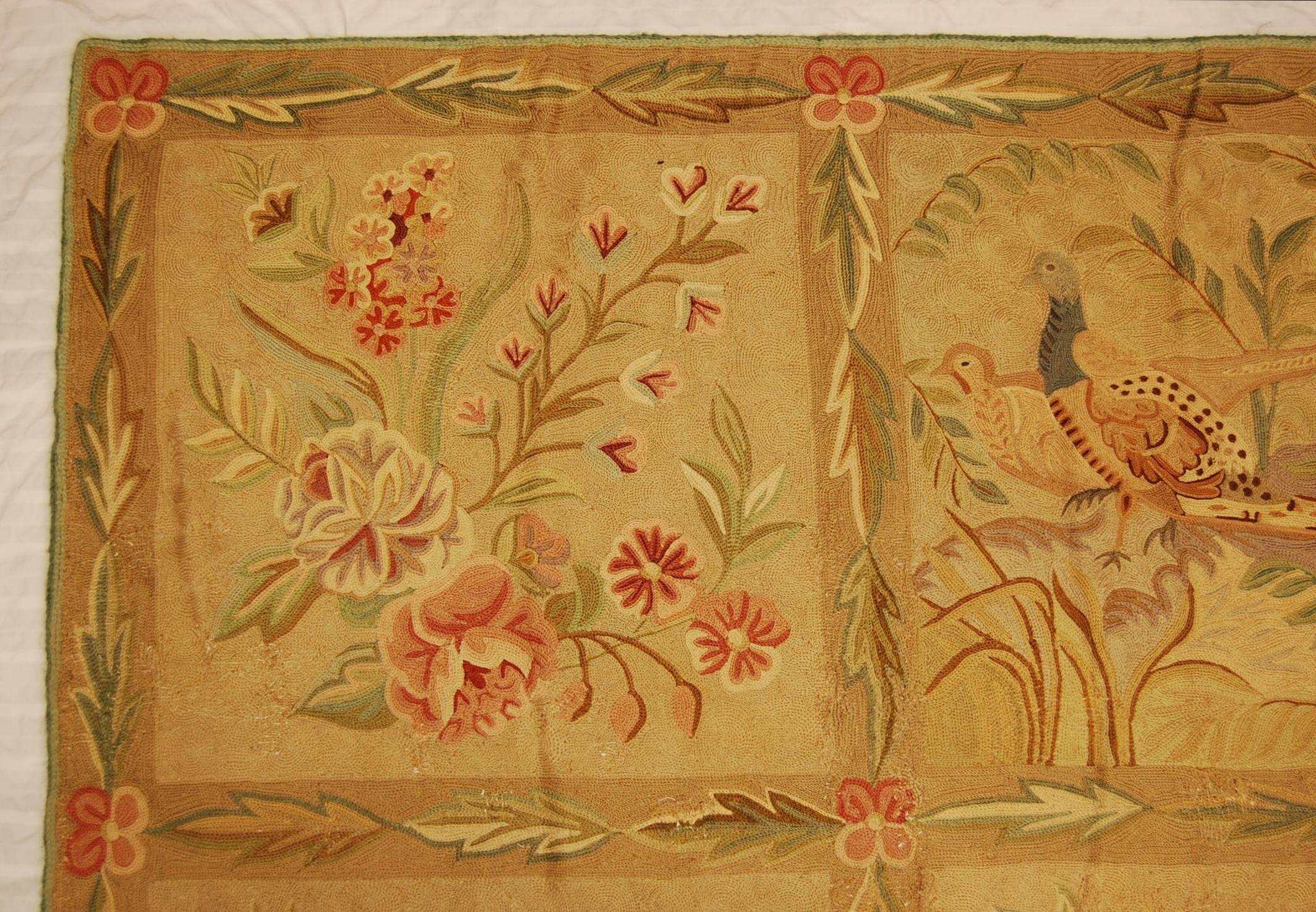 Made by the F. Schumacher Company who imported them from India from the 1930s-1960s. These were sold through their New York showroom and were available in several different sizes. This rug shows various birds and vegetation on a natural colored