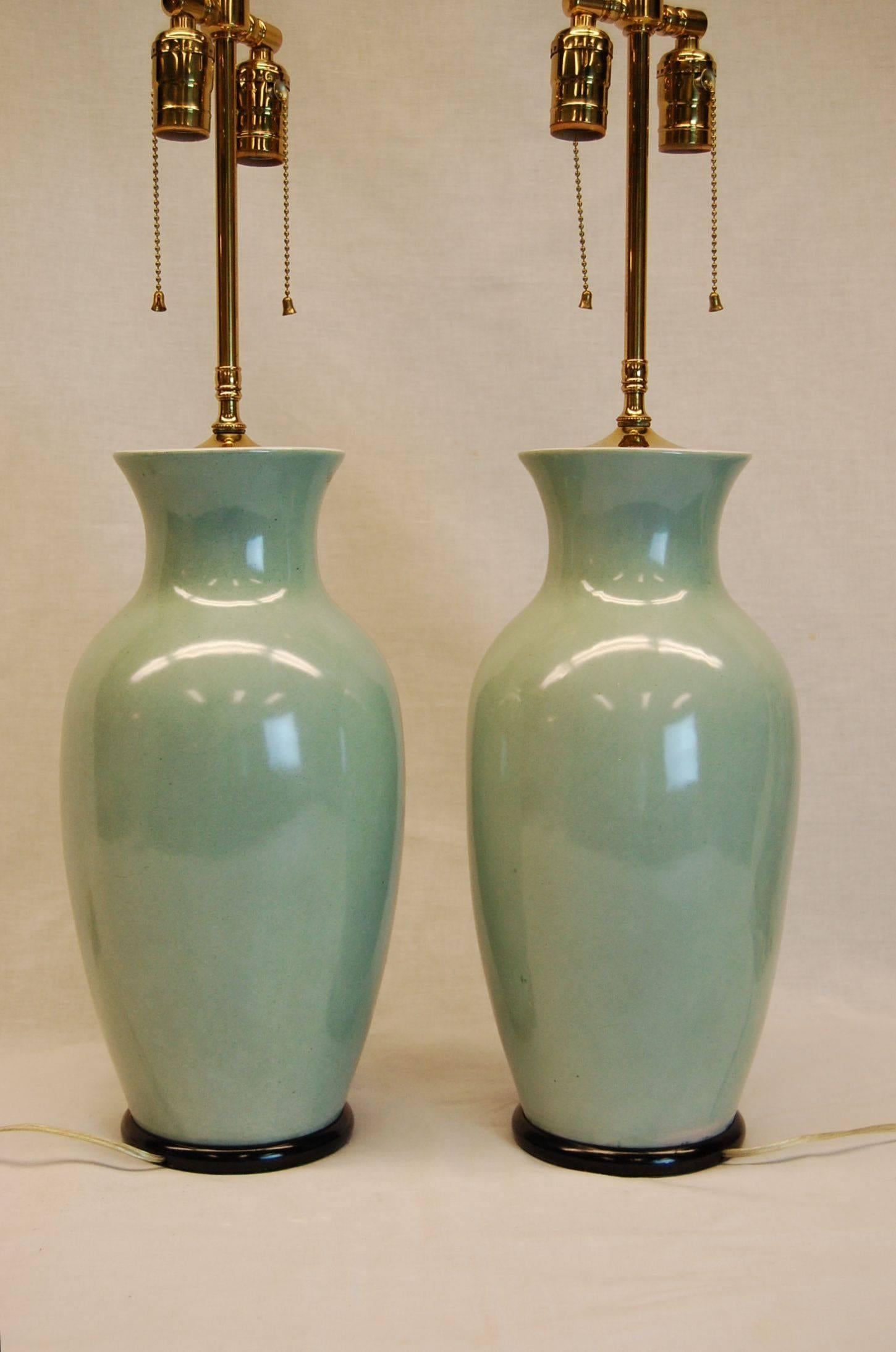 Pair of mint condition urns wired as lamps on wooden bases, wired with three way sockets. 16