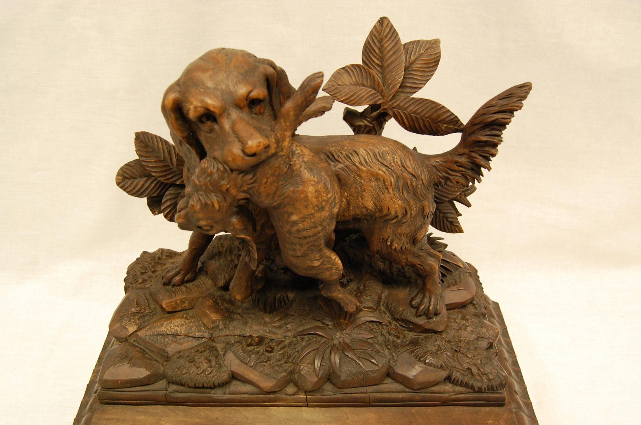 Highly detailed carving of a hunting dog after retrieving his rabbit. Mounted onto a lambs tongue base. The actual carving is 6" x 14 1/4" x 11" tall; The dimensions of the bottom is 8" x 17" wide.