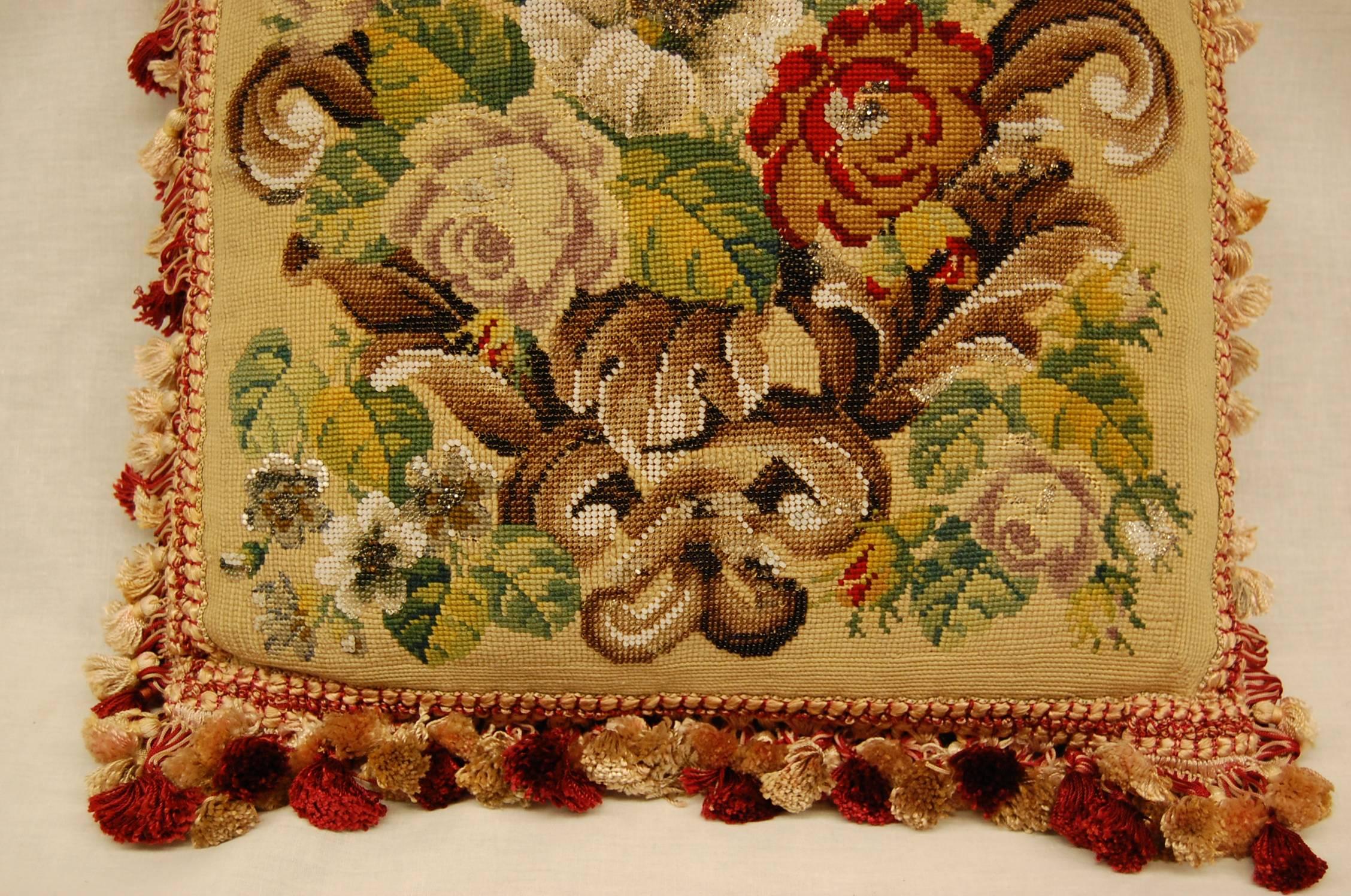 There is so much going on in this piece of needlepoint; multiple colors of glass beads and a complex floral design make this a very unique pillow.