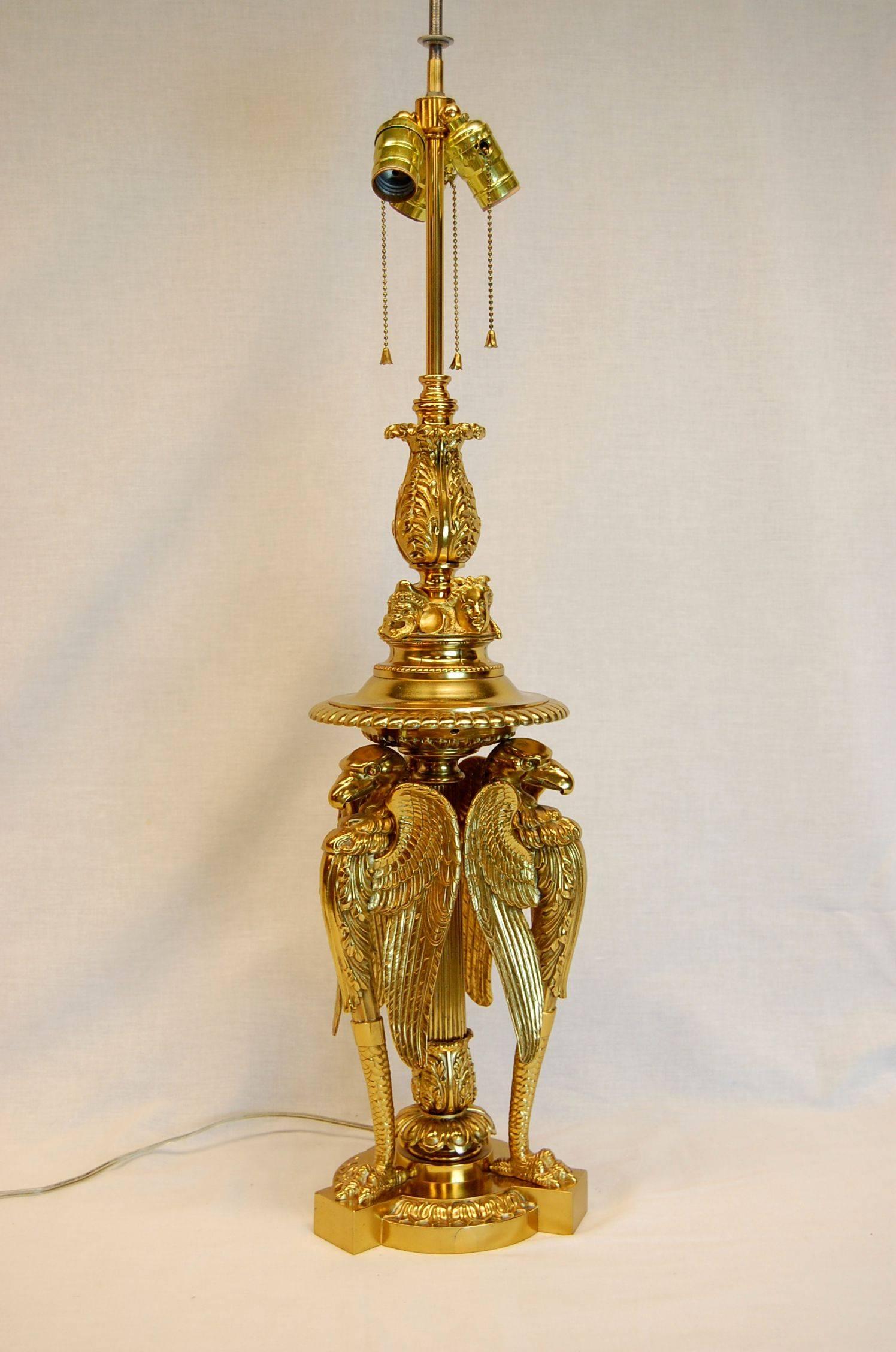This exquisite lamp comes with the custom-made silk shade with custom tassel trim. Three fantastic Bald Eagles with wings partially spread surmount the center column.