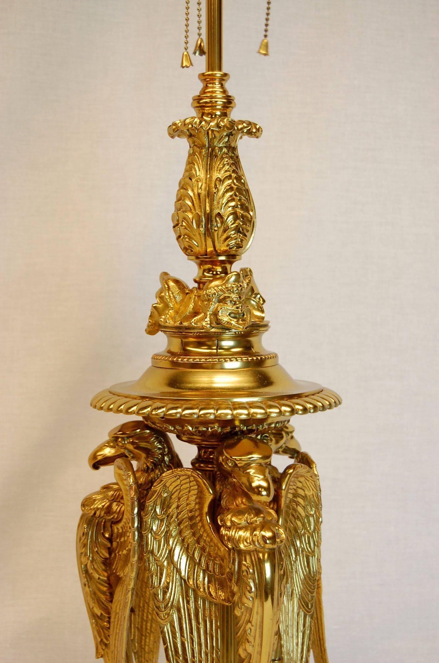 European Large Gilt Brass Table Lamp Featuring Three Large Eagles For Sale