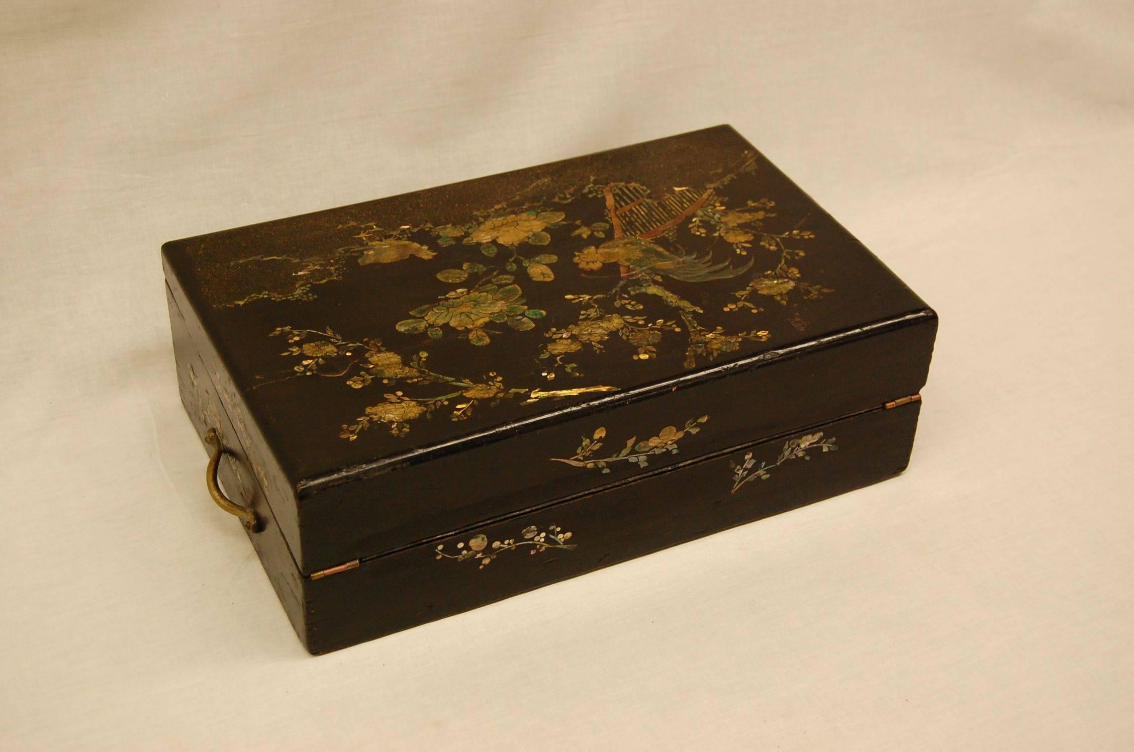 Very nice wooden box in black lacquered finish with original key which still works the lock, circa 1850. Detailed mother-of-Pearl inlay of roosters and flowering trees. Interior lid and tray functions perfectly. Either Japanese or Chinese in origin.