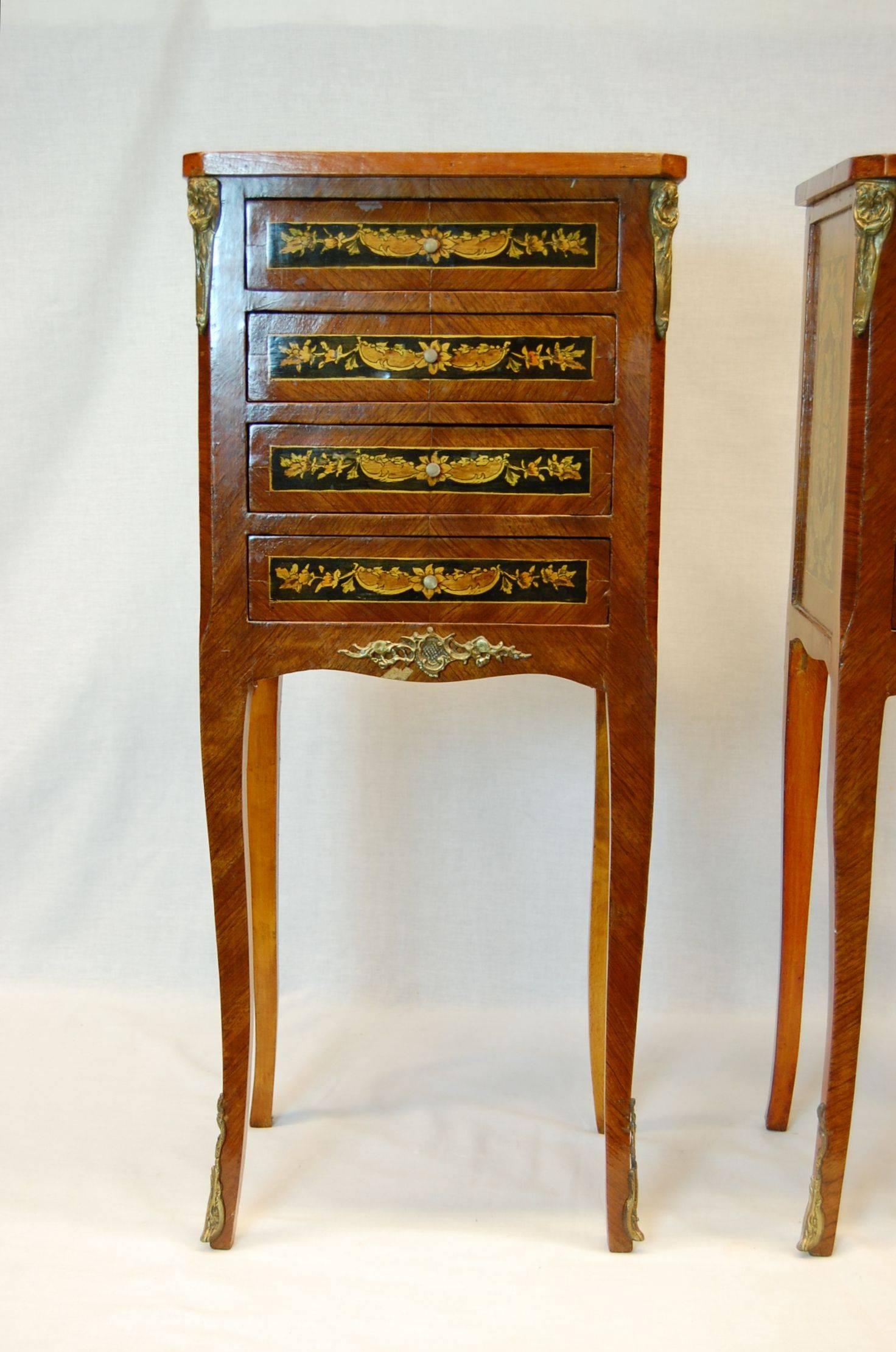 Pair of inlaid wooden night tables with four drawers in good condition.
