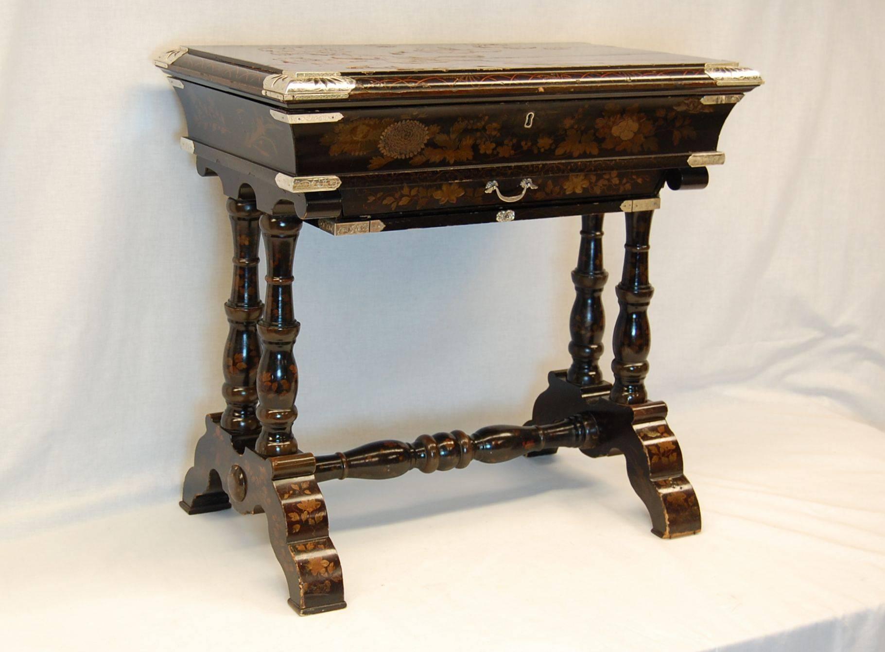A very special Japanned lacquered writing table, circa 1860. With silver plated mounts, one drawer and pull-out tray with blue Ostrich panel. The interior is fitted with three separate compartments, all of which are completely removable.