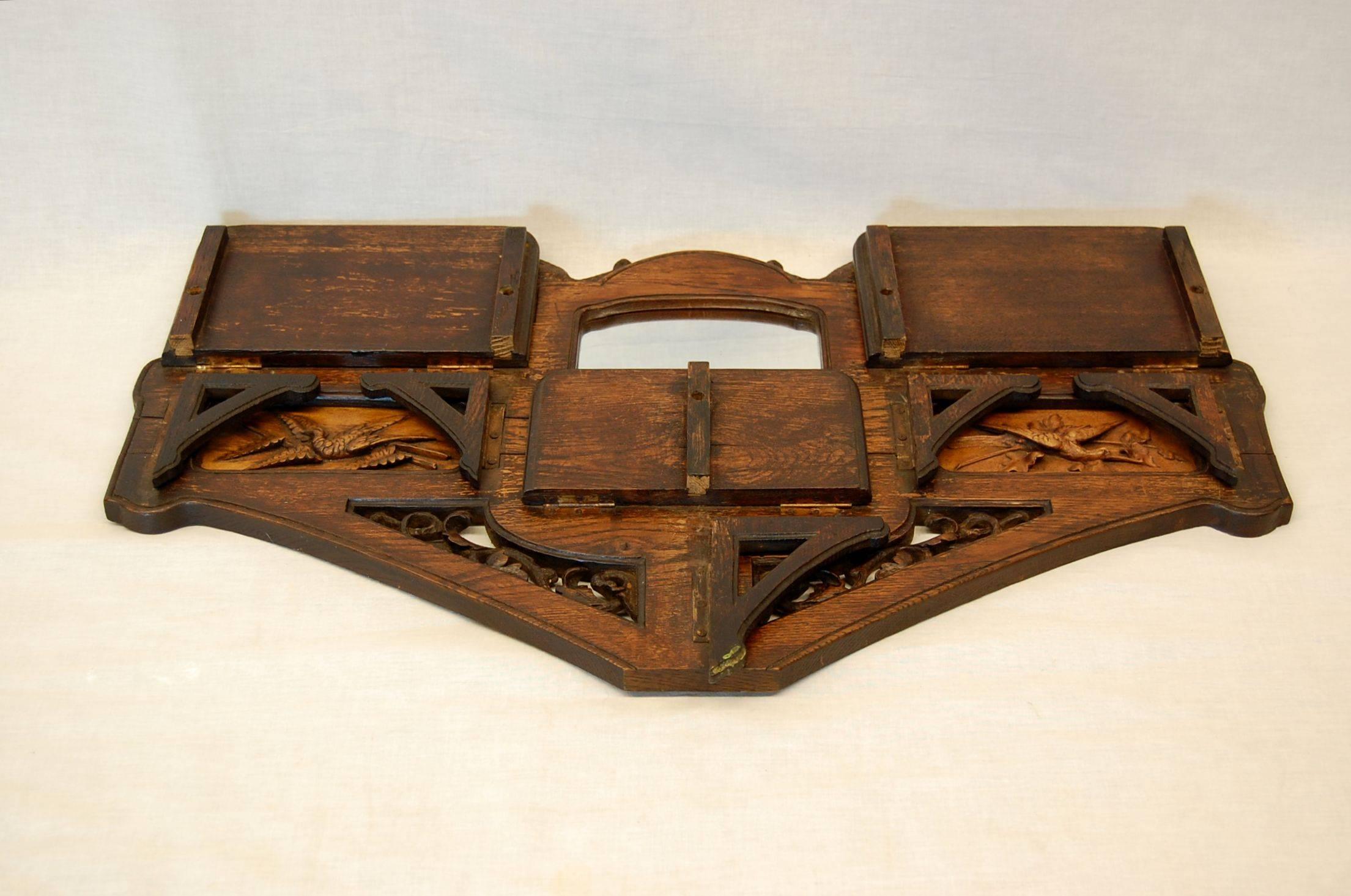 Exceptional carved wood wall shelf with mirror for shaving. Two wonderful monkeys and a pair of cranes in flight adorn this piece. The cranes are carved from a wood that is lighter in color and stands out from the oak. Very solid piece, shelves and