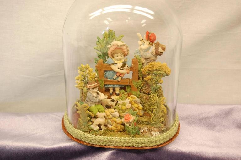 Whimsical garden scene featuring children playing in the garden. Very nice condition with new glass dome.