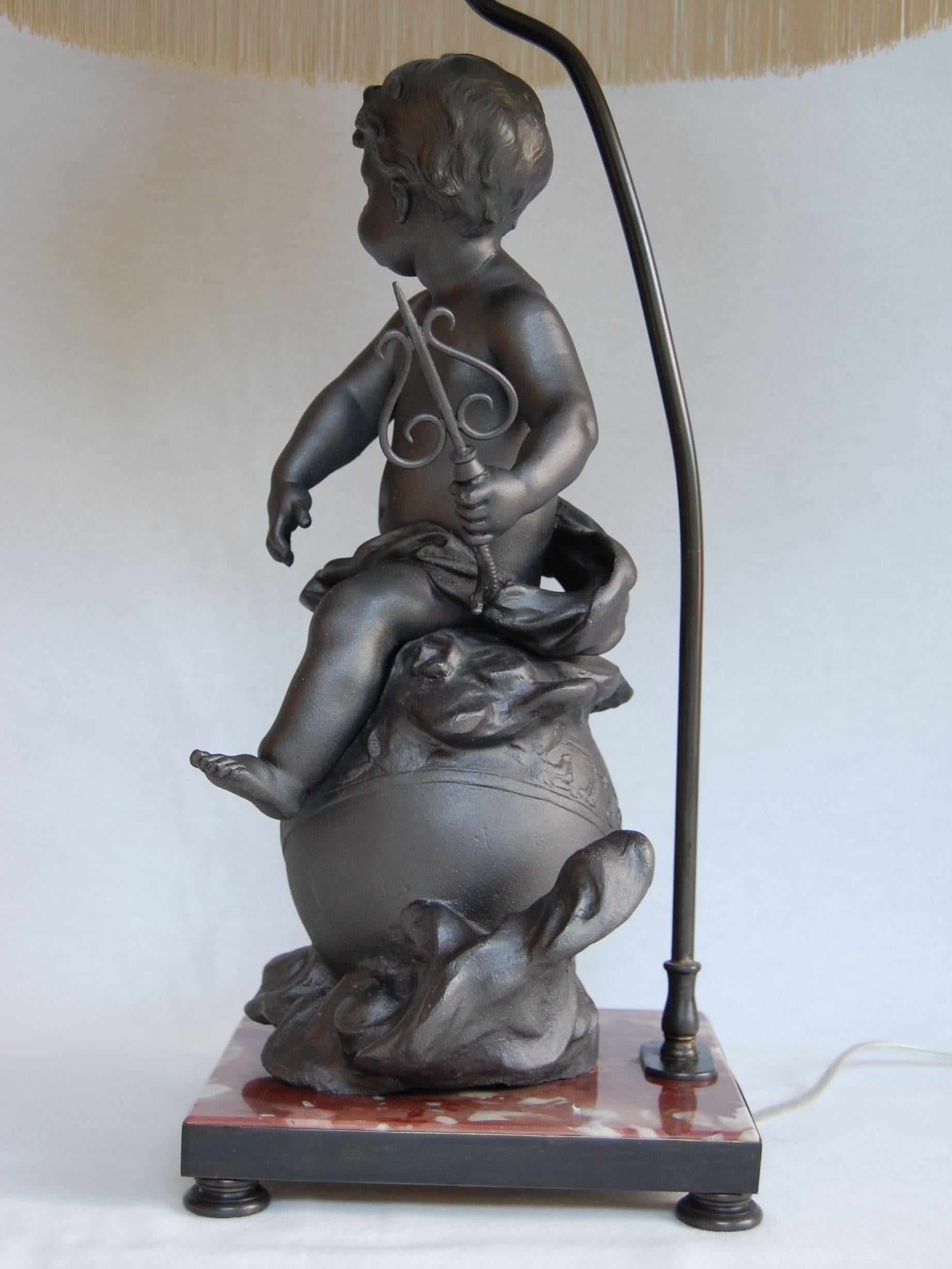 American Lead Cherub Figure Wired as a Lamp on a Marble Base For Sale