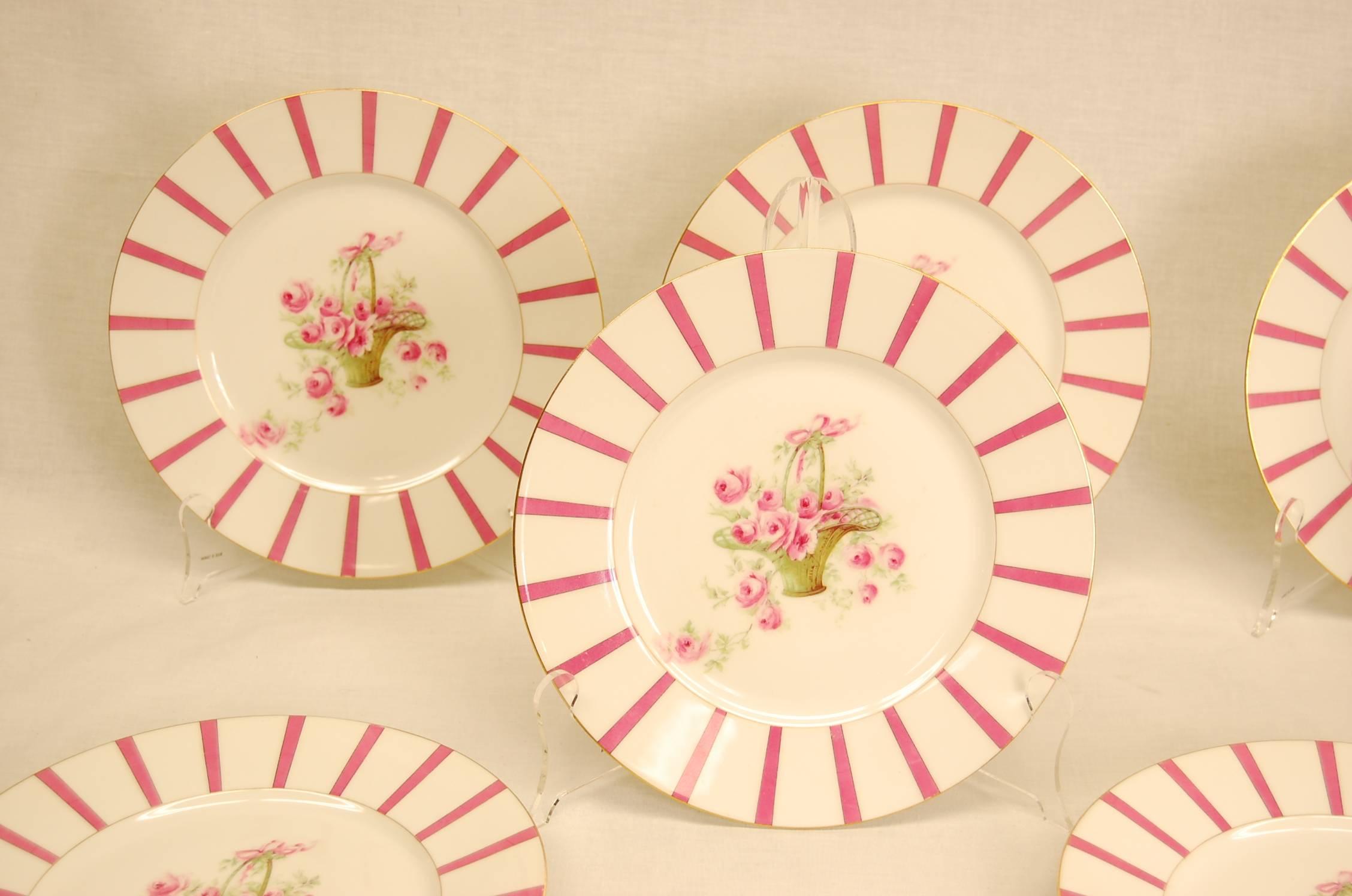 11 porcelain plates by Limoges measures 9 7/8 in diameter, all in excellent condition (one small chip as shown) each plate has a basket of flowers with pink roses and greens.