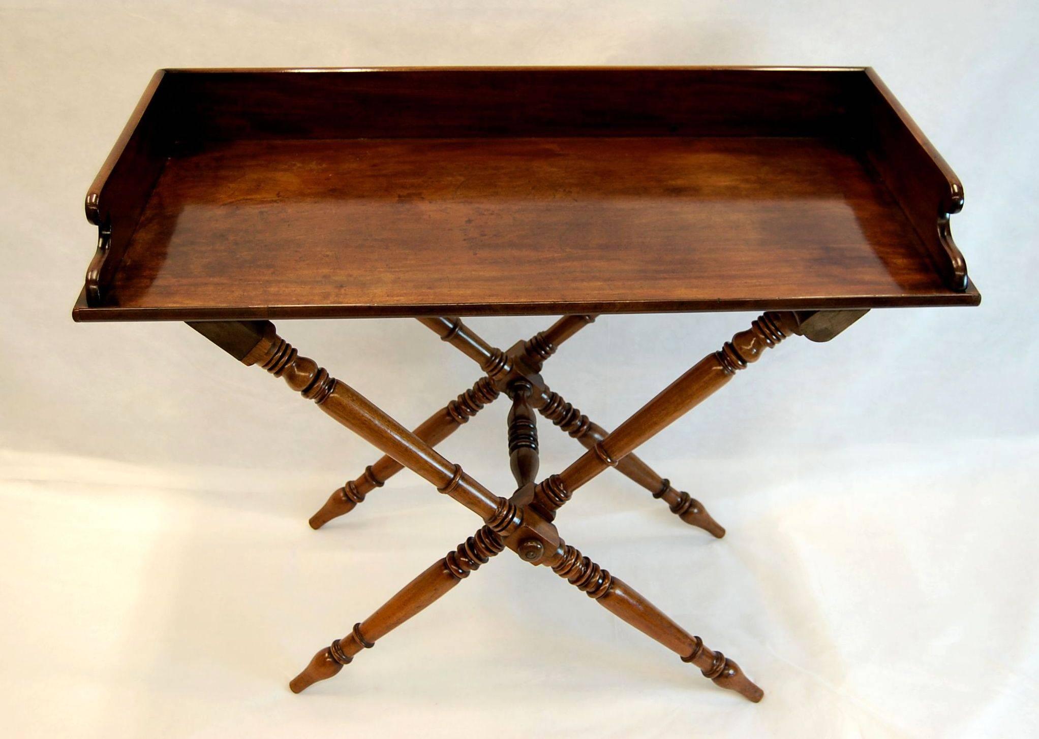 Large, beautiful and useful mahogany tray table on a tall X-frame folding base. Just cleaned and polished, leaving a wonderful lustrous table, circa 1860.