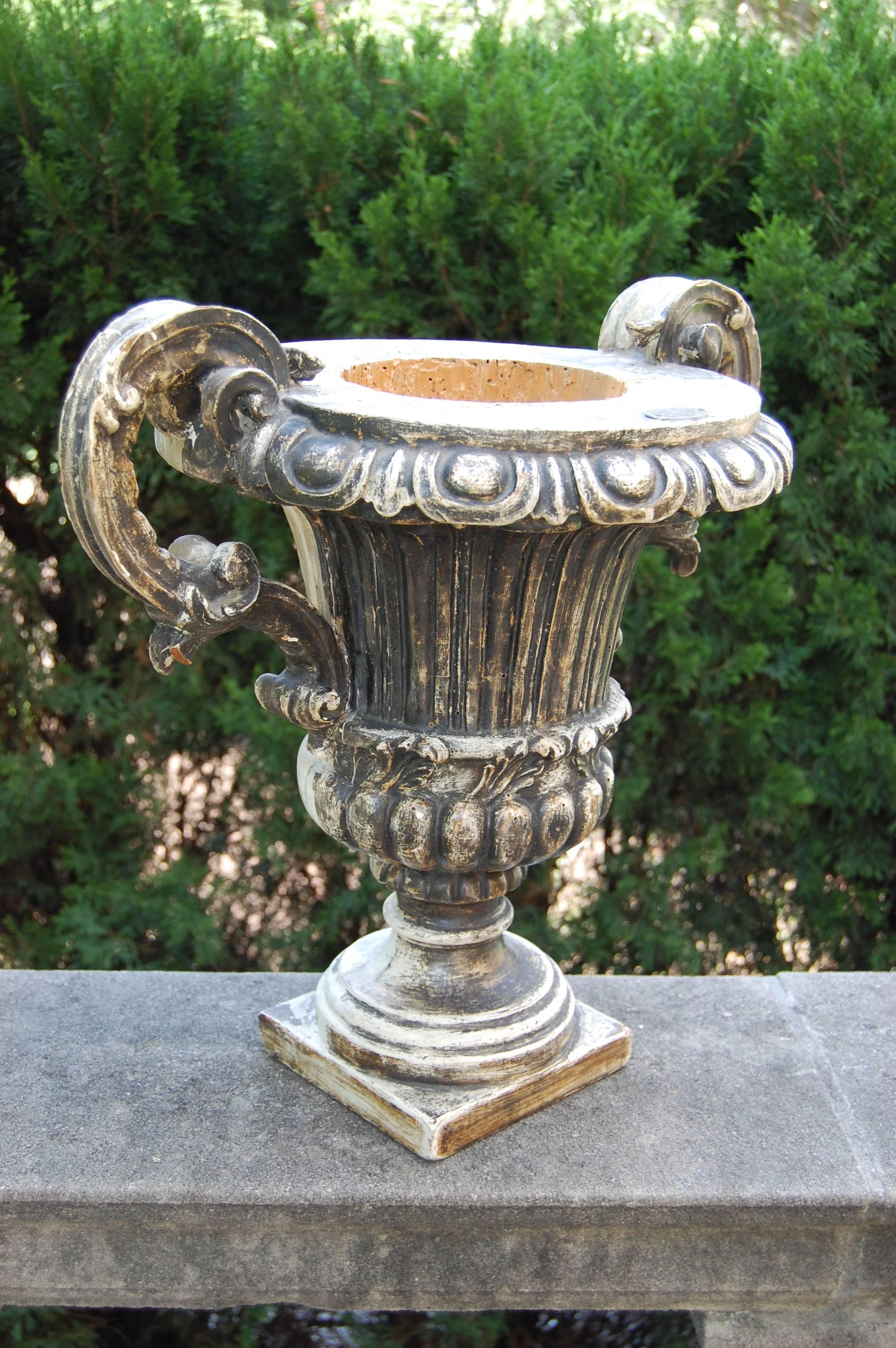 This carved wooden urn was hollowed out to receive a vessel for holding flowers and is only decorated on one side. This was likely a very early 19th century church altar piece. Ospedale Di Prato is the name on the plate.