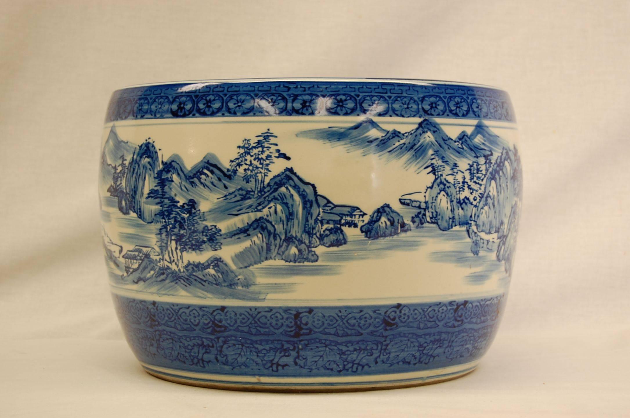 Beautiful blue and white glazed urn decorated with mountain scenes, trees and lakes in perfect condition.