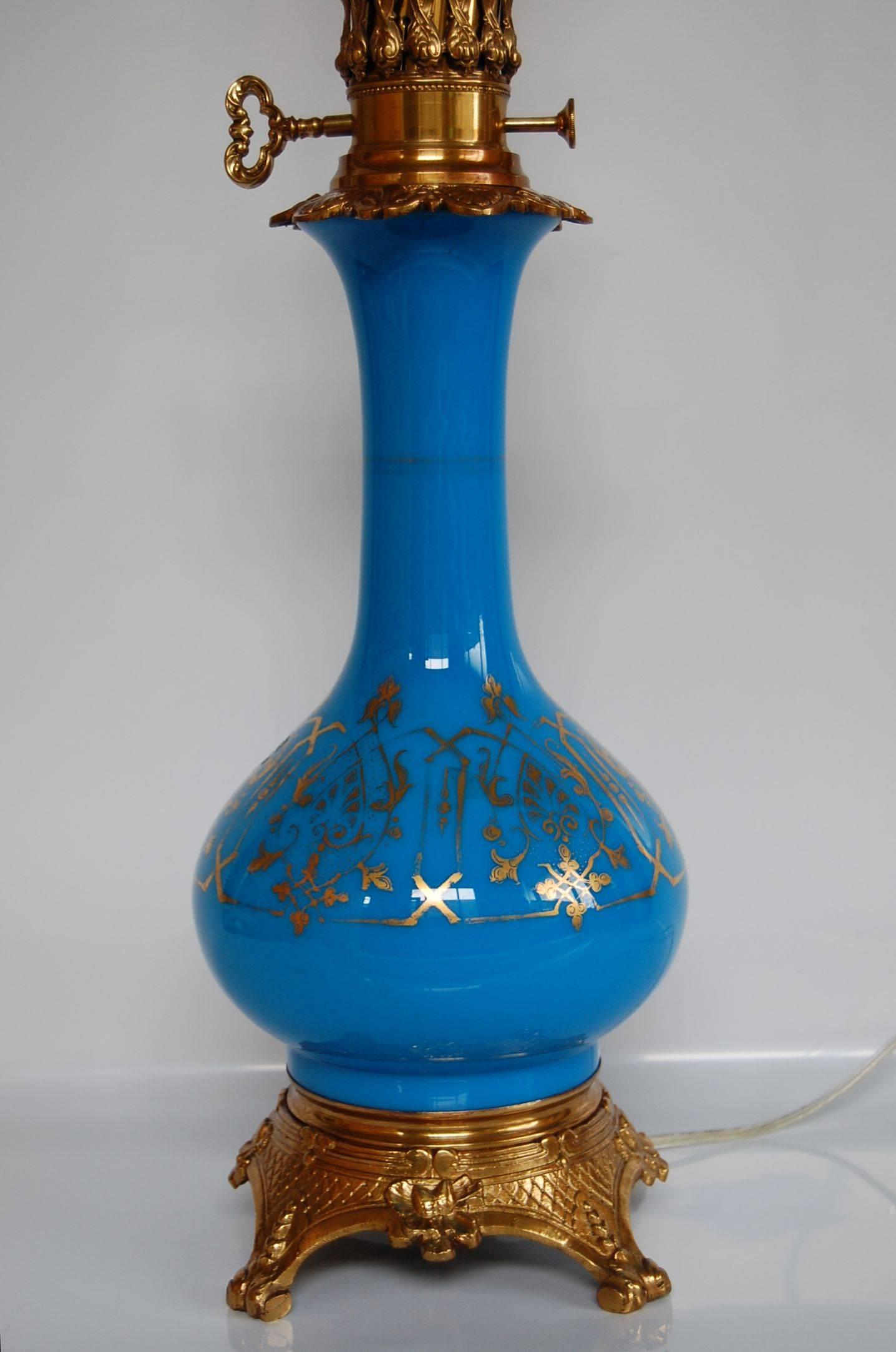 This beautiful lamp has recently been cleaned, polished and rewired with a three way socket. The blue glass is stunning and the gold leaf decoration is in excellent condition.