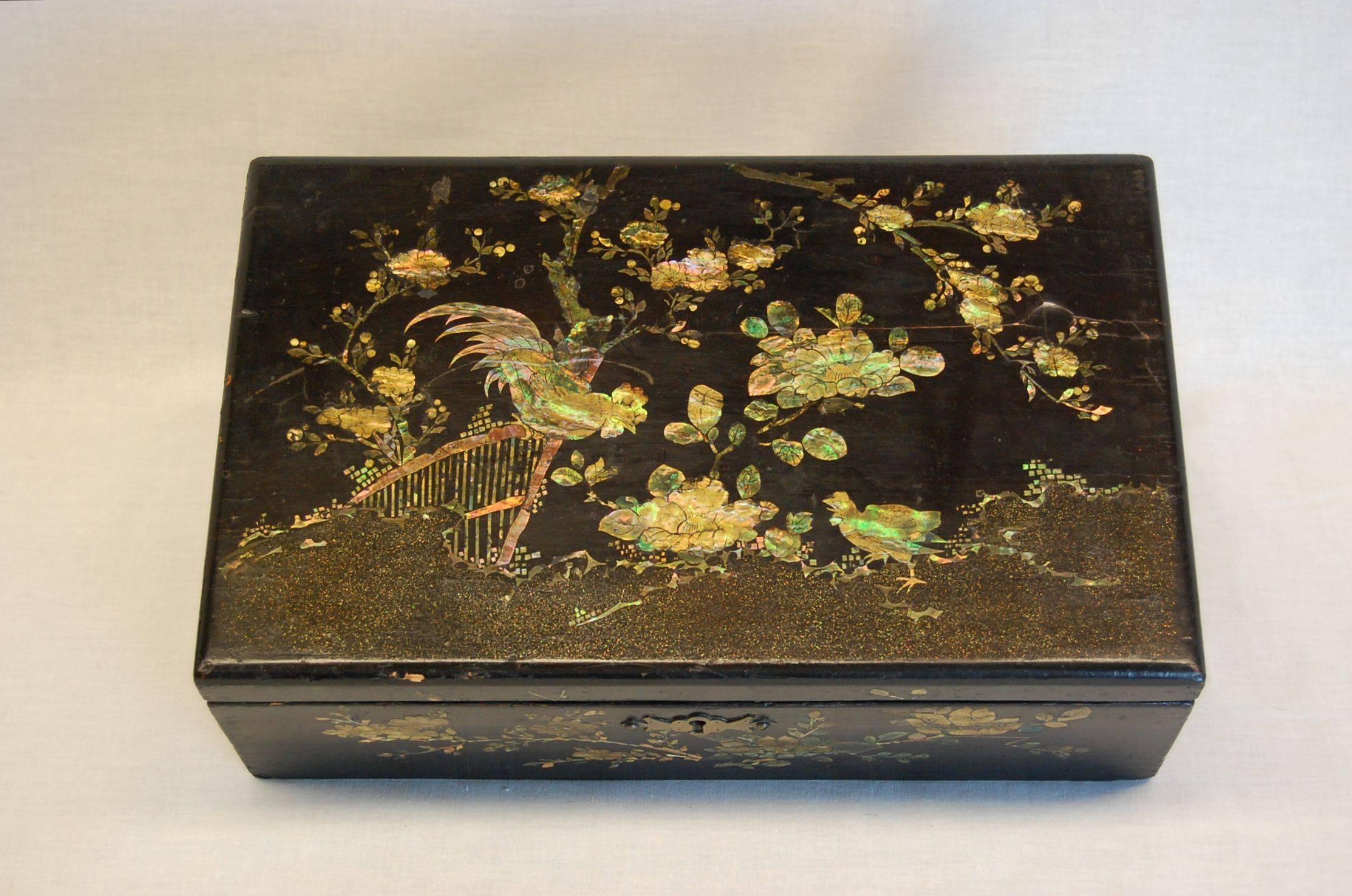 Very nice wooden box in black lacquered finish with original key which still operates the lock, circa 1850. Detailed mother-of-Pearl inlay of roosters and flowering trees. Interior lid and tray functions perfectly.