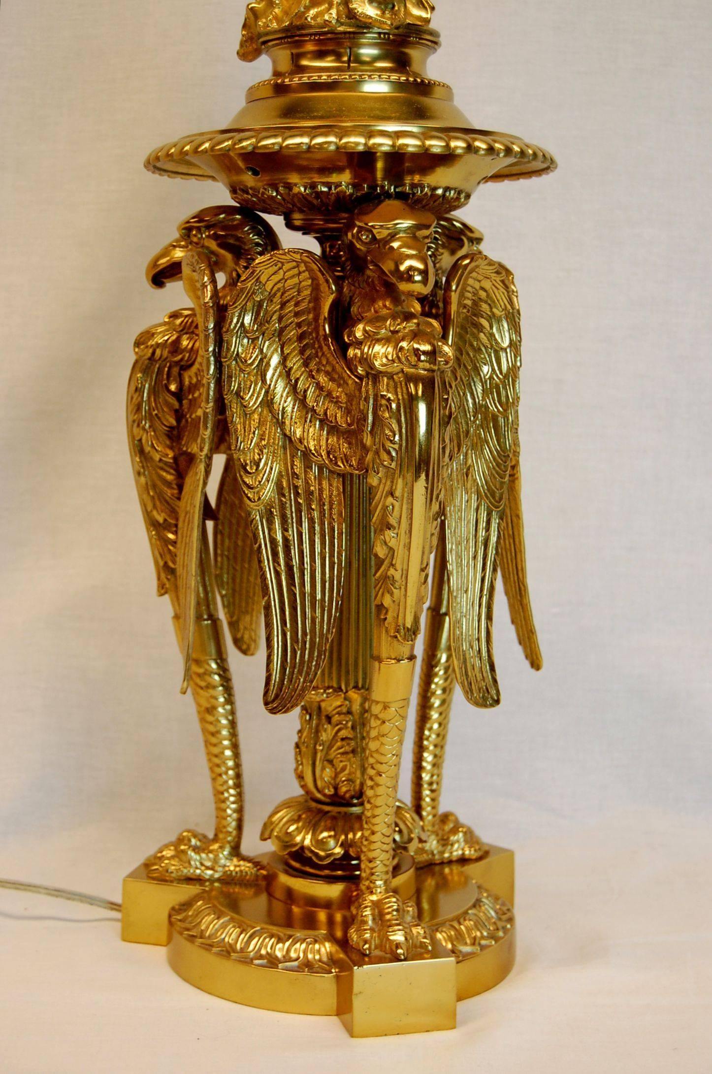 Exquisite lamp comes with this custom-made silk shade with custom tassel trim. Three fantastic bald eagles with wings partially spread surmount the center column.