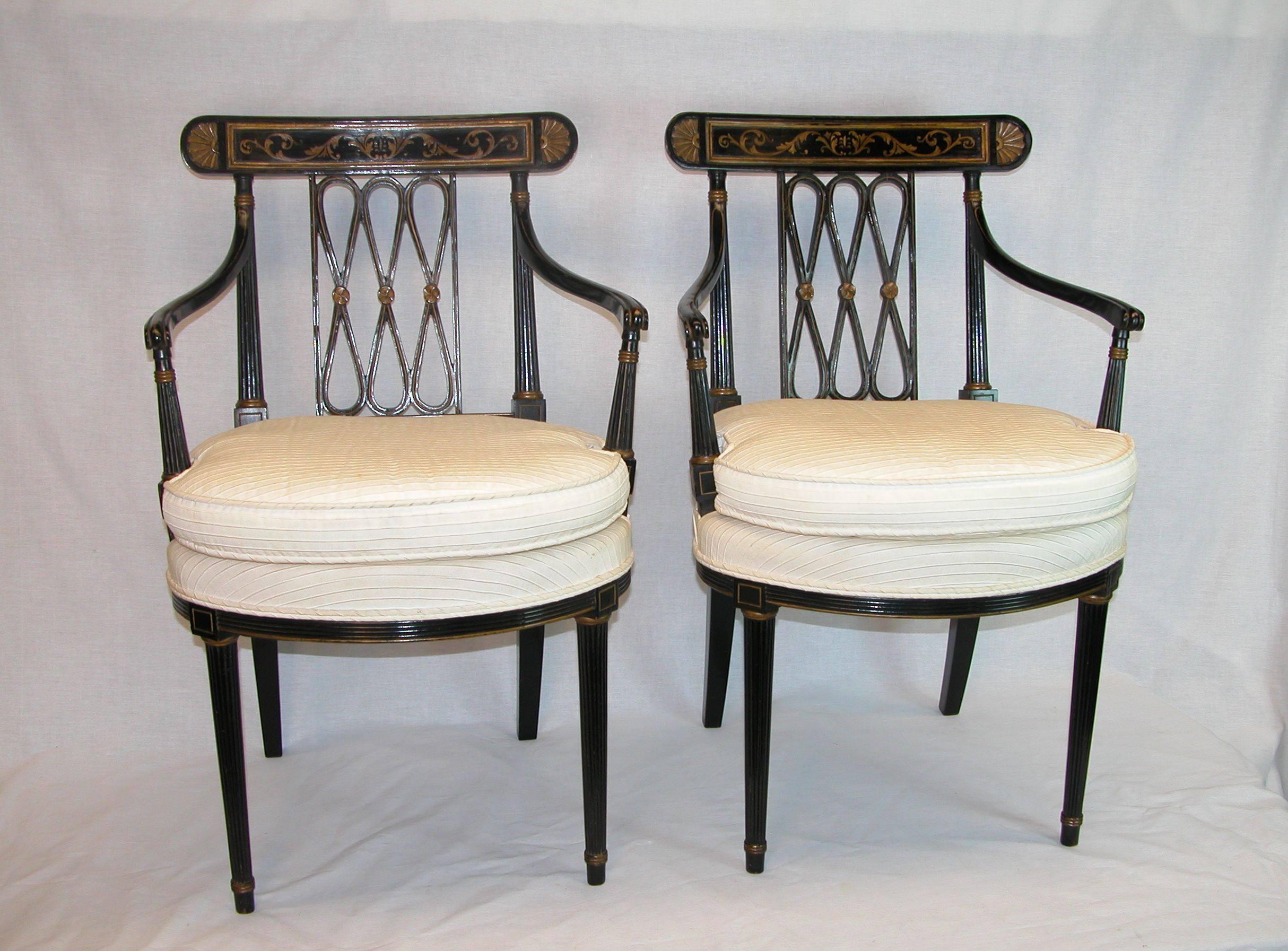 Pair of black lacquered Regency open-armchairs with diamond/ ribbon backs and gold classical decoration. Wonderful narrow carved and curved arms above tapered ribbed supports, the apron is also carved with ribs as well as the legs. Upholstered with