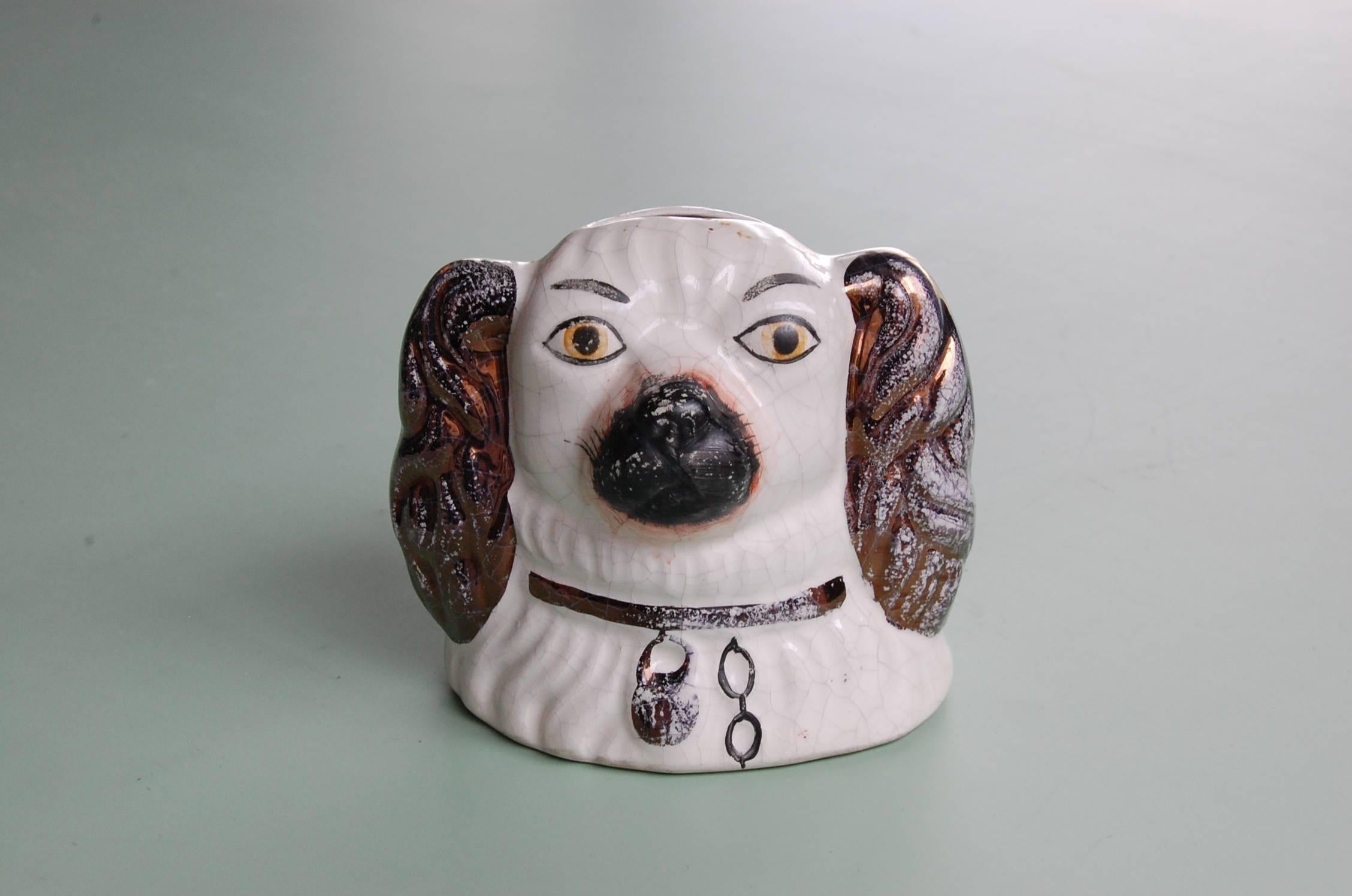 Perfect bank Staffordshire bank made in the image of a Spaniels head. Measures: 4 3/4 inches wide and 4 1/4 inches tall.