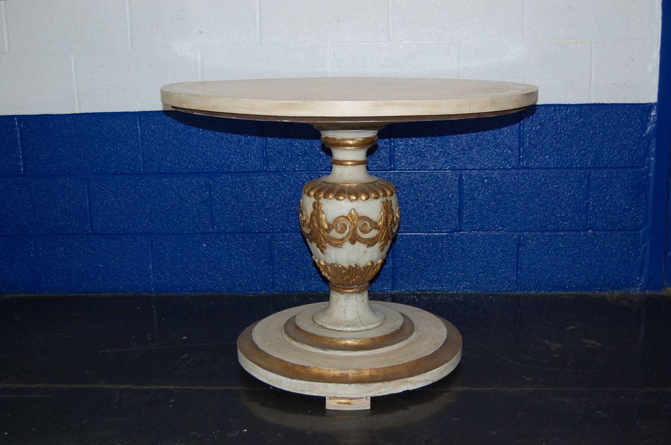 Painted breakfast table possibly imported by Michellini. Very heavy carved wood urn shaped column on circular base with gold leaf accents, 28 inches tall. Original glazed finish to appear as antique, Measures: 35 3/4 inches in diameter.