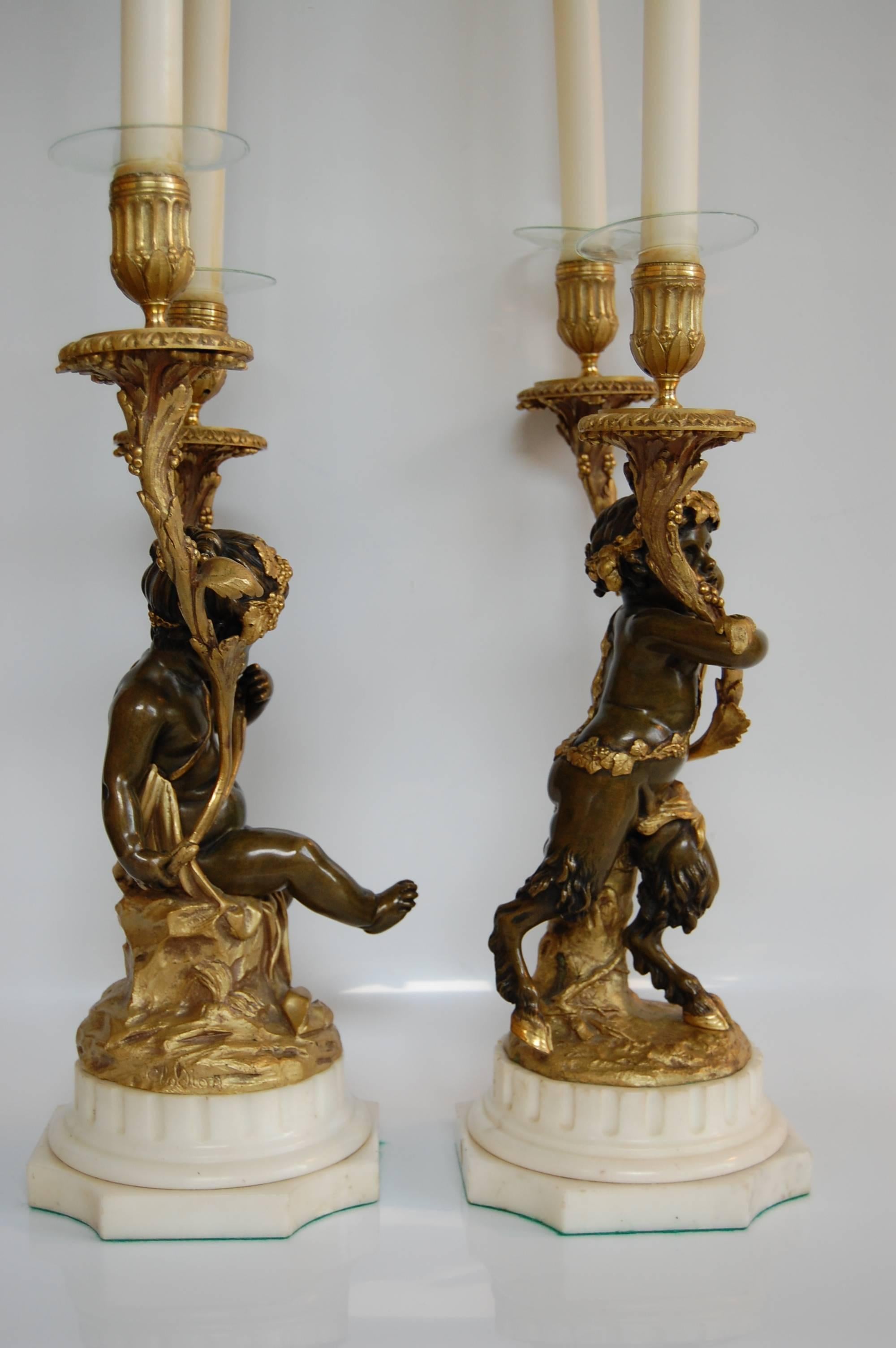 This pair of gilt and patinated candelabra are in excellent condition and make quite a statement. The finish on both the metal and marble are in excellent condition. Originally wired, it has since been removed for candle burning, but can be