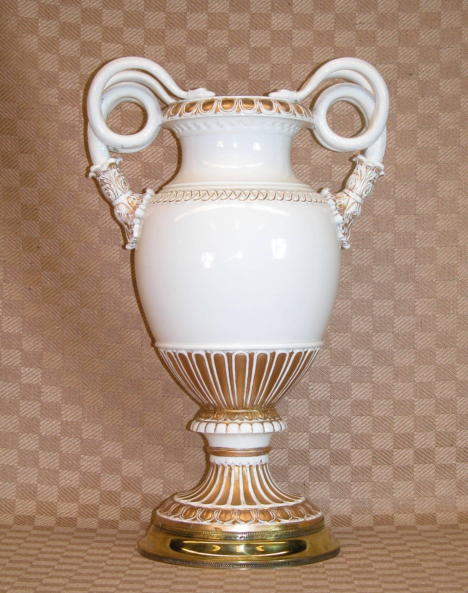 Meissen porcelain vase, Germany, mid-late 19th century, with scrolled snake handles, gilding to rim, handle terminals, lower body, and socle, crossed swords marks, ht. 15 3/8 inches tall. Resting on a brass base and includes a tubular brass liner to
