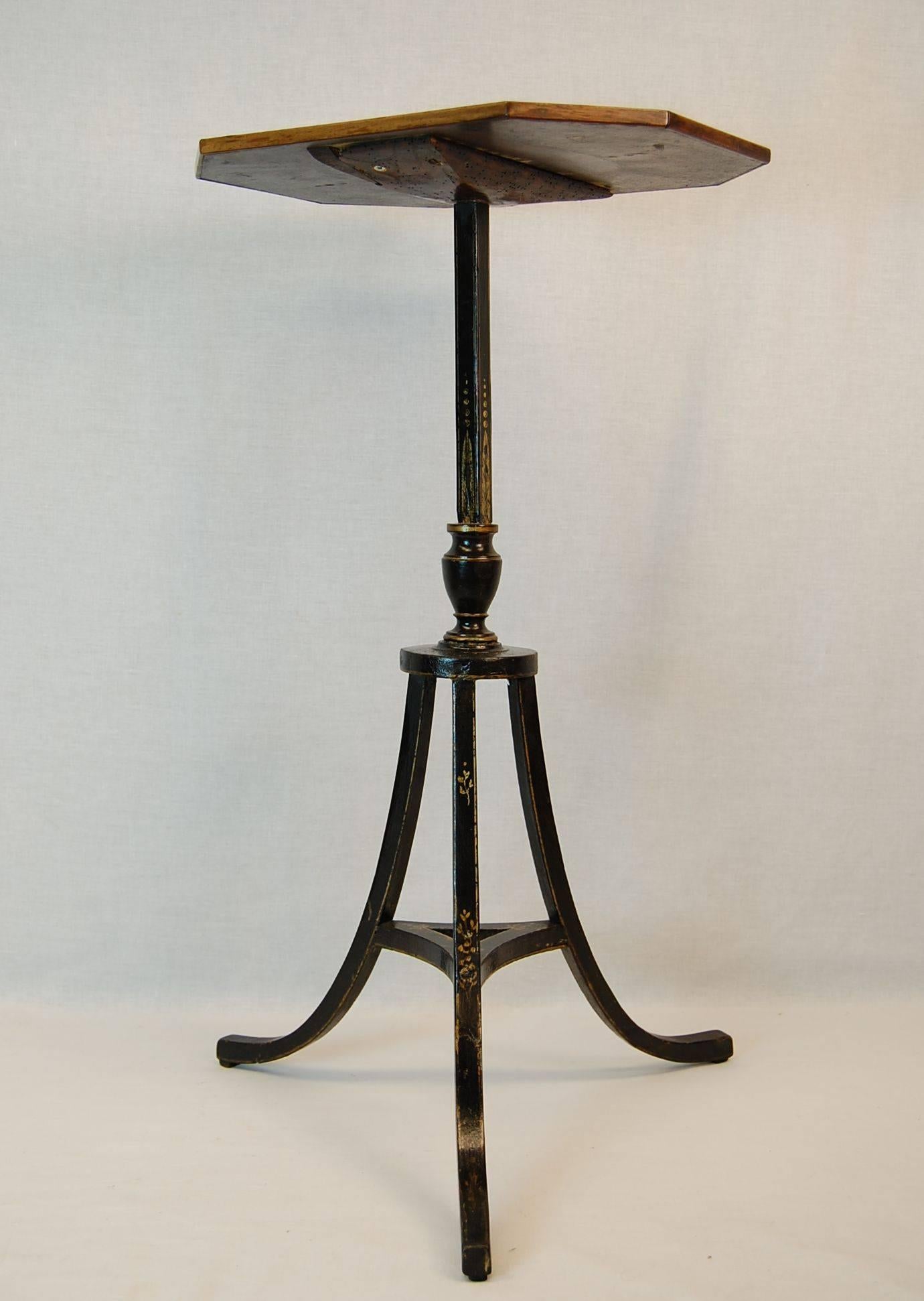 Mahogany hexagonal top with black painted and gold decorated tripod base, this is an original table, not a fire screen stand attached to a later top.