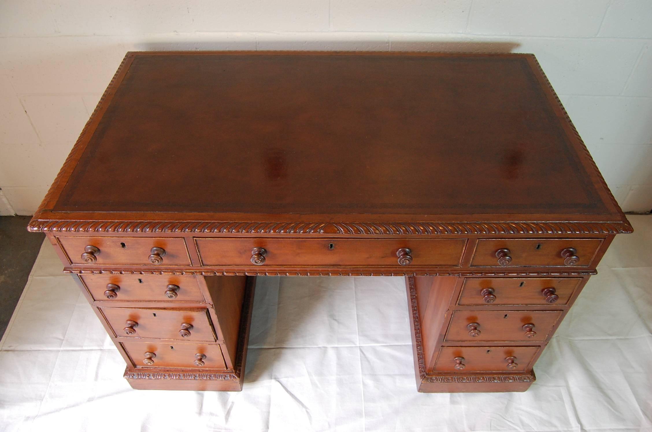 Mahogany Georgian style Partners desk with leather top in good condition, original castors.