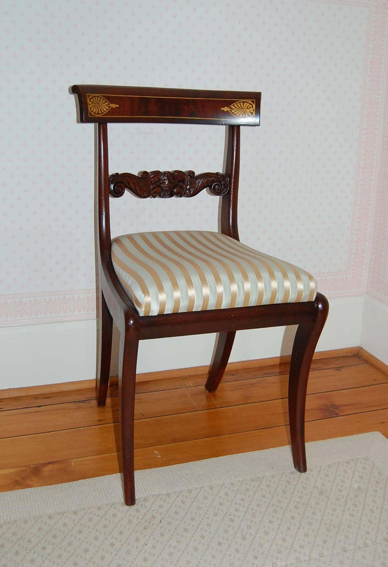 Pair of mahogany side chairs, circa 1820-1830, in the style of Anthony G. Quervelle, recently recovered in a striped silk fabric by Scalamandre #154-001, Provence Satin Tafetta. Very good condition with some old restoration/ repairs. These chairs