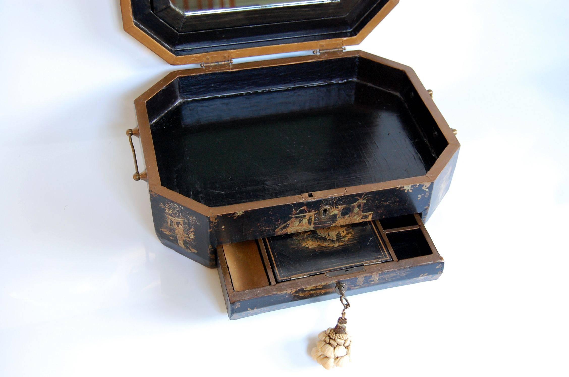 Chinese lacquered sewing box decorated with gold floral patterns and Chinoiserie figures on the top and front, done with exquisite detail, in very fine condition.