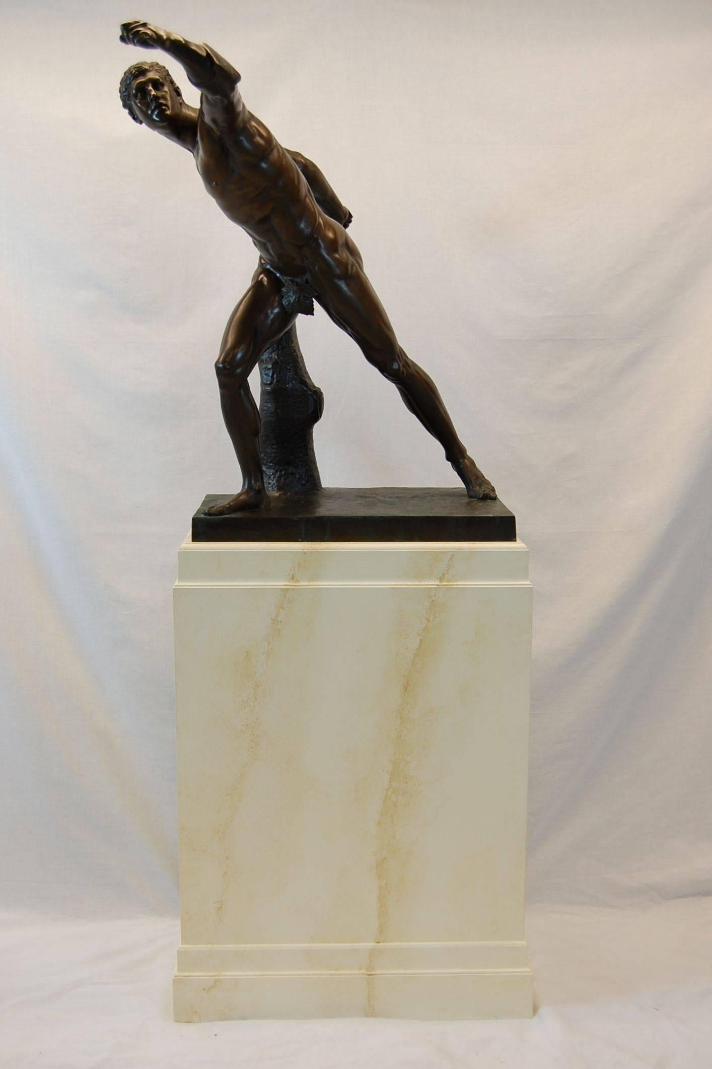 Excellent bronze casting of a Borghese gladiator resting atop a wooden plinth, stamped Tiffany & Co. on the rear, flat surface. The custom marbleized wooden base (by Hadleigh Furn. Co.) measures 34.5