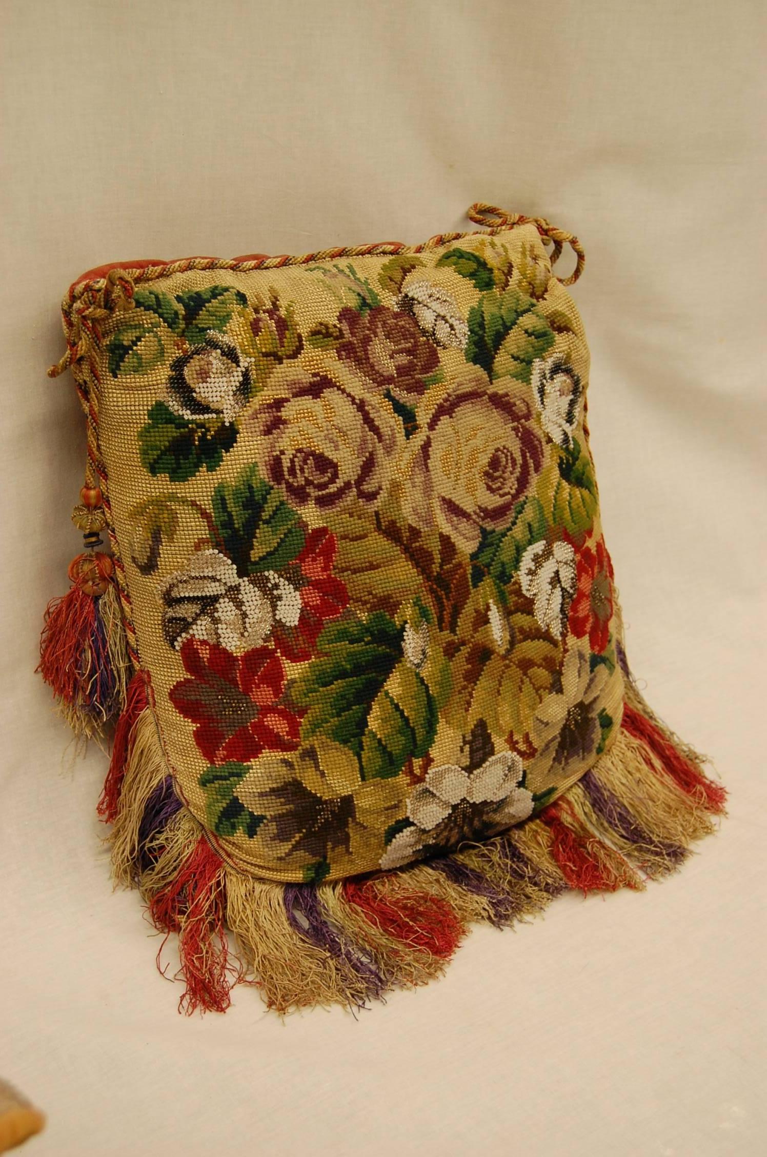 Wonderful piece of needlepoint with multicolored glass beads attached as a pillow with two tassels and fringe. Excellent condition.