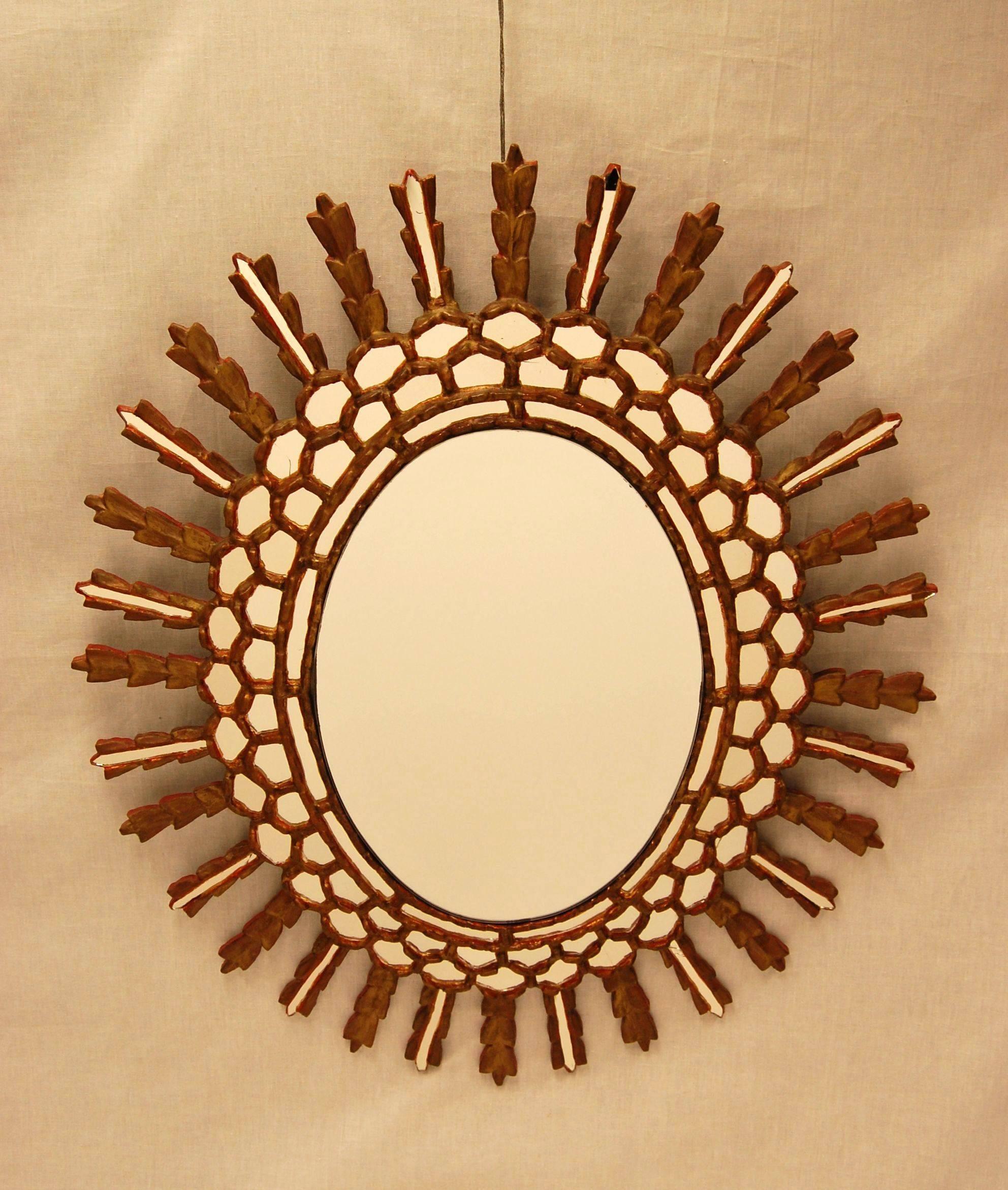 1950s oval mirror in excellent condition with newer beveled center glass. All surrounding pieces of mirror are original.