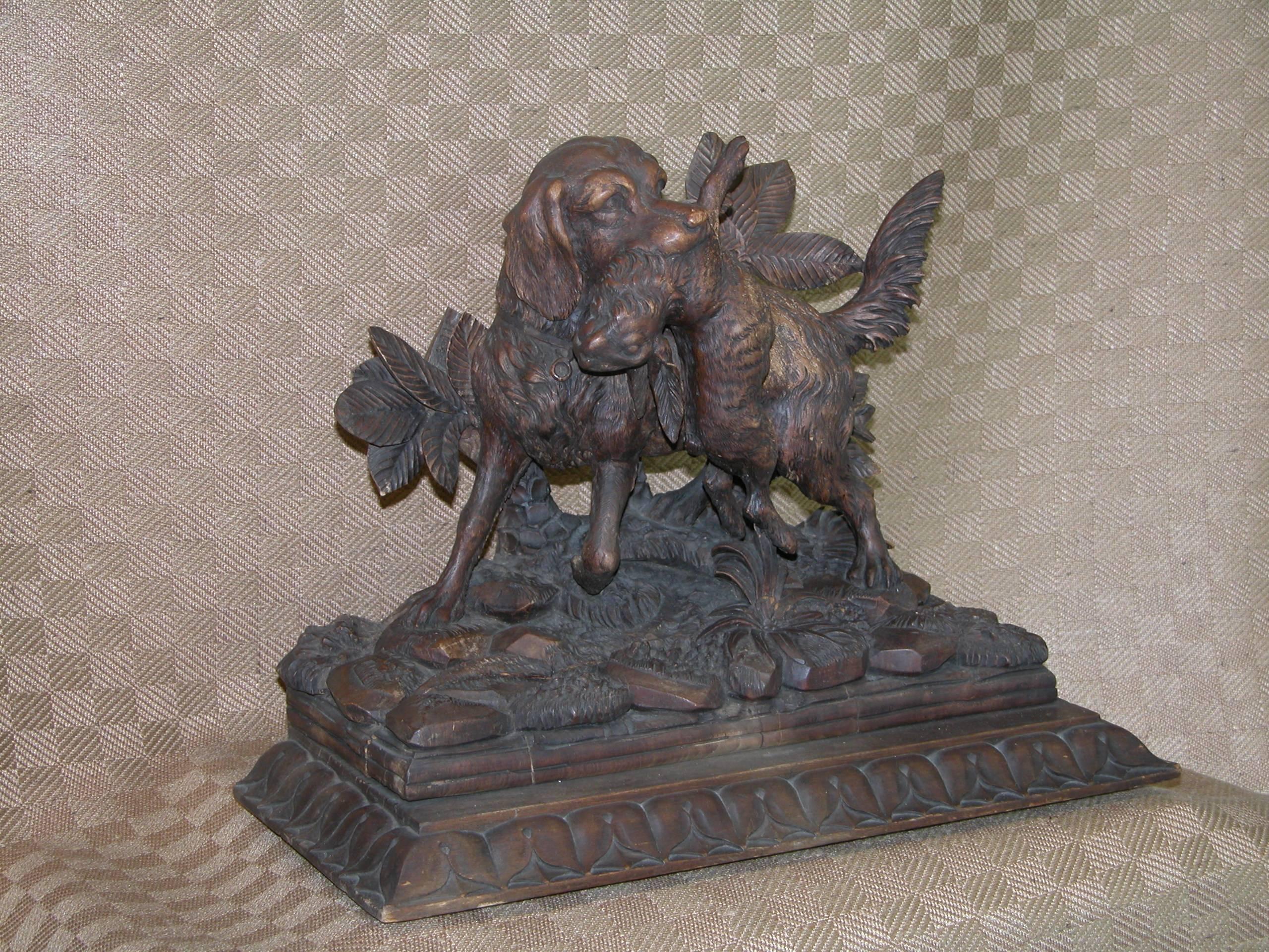 Highly detailed carving of a hunting dog after retrieving his rabbit. Mounted onto a lambs tongue base. Extremely well done and in excellent condition. Dimensions: Base; 8 x 17 x 1 1/4 inches tall; Carving: 6 x 14 x 11 5/8 inches tall, total height