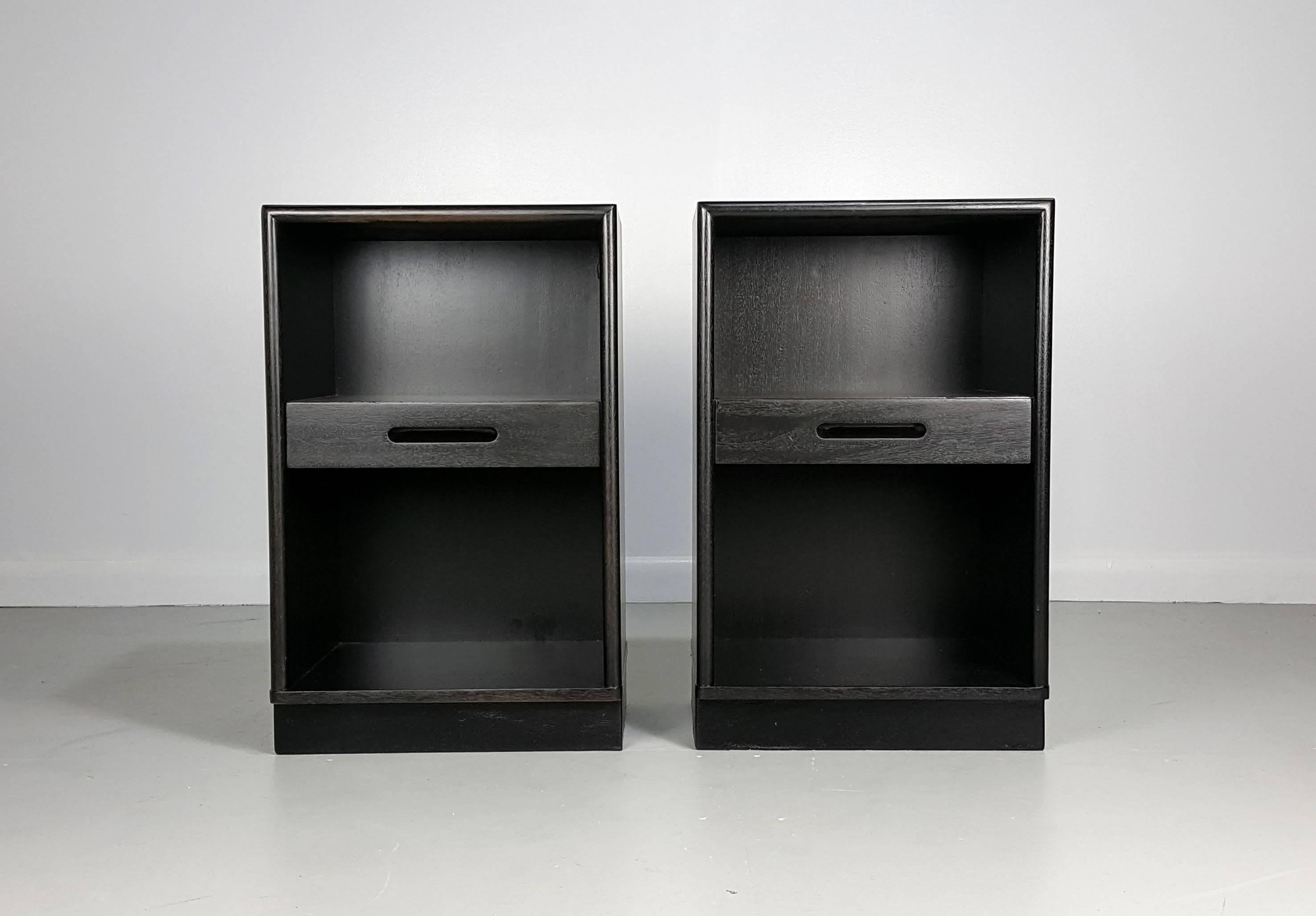 Handsome ebonized mahogany nightstands with leather plinth bases by Edward Wormley for Dunbar, 1950s. Fully restored and in excellent condition.

We offer free regular deliveries to NYC and Philadelphia area. Delivery to DC, MD, CT and MA are