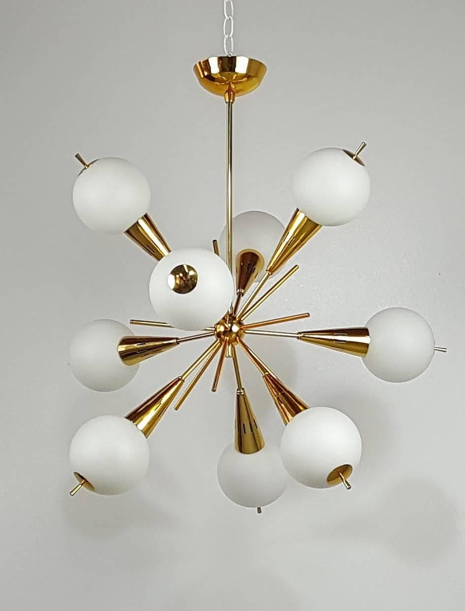 Stunning nine-globe Sputnik chandelier attributed to Stilnovo, Italy, 1950s. Globes are handblown in frosted glass. This piece has been fully restored in a gold-toned brass finish. 

We offer free regular deliveries to NYC and Philadelphia area.
