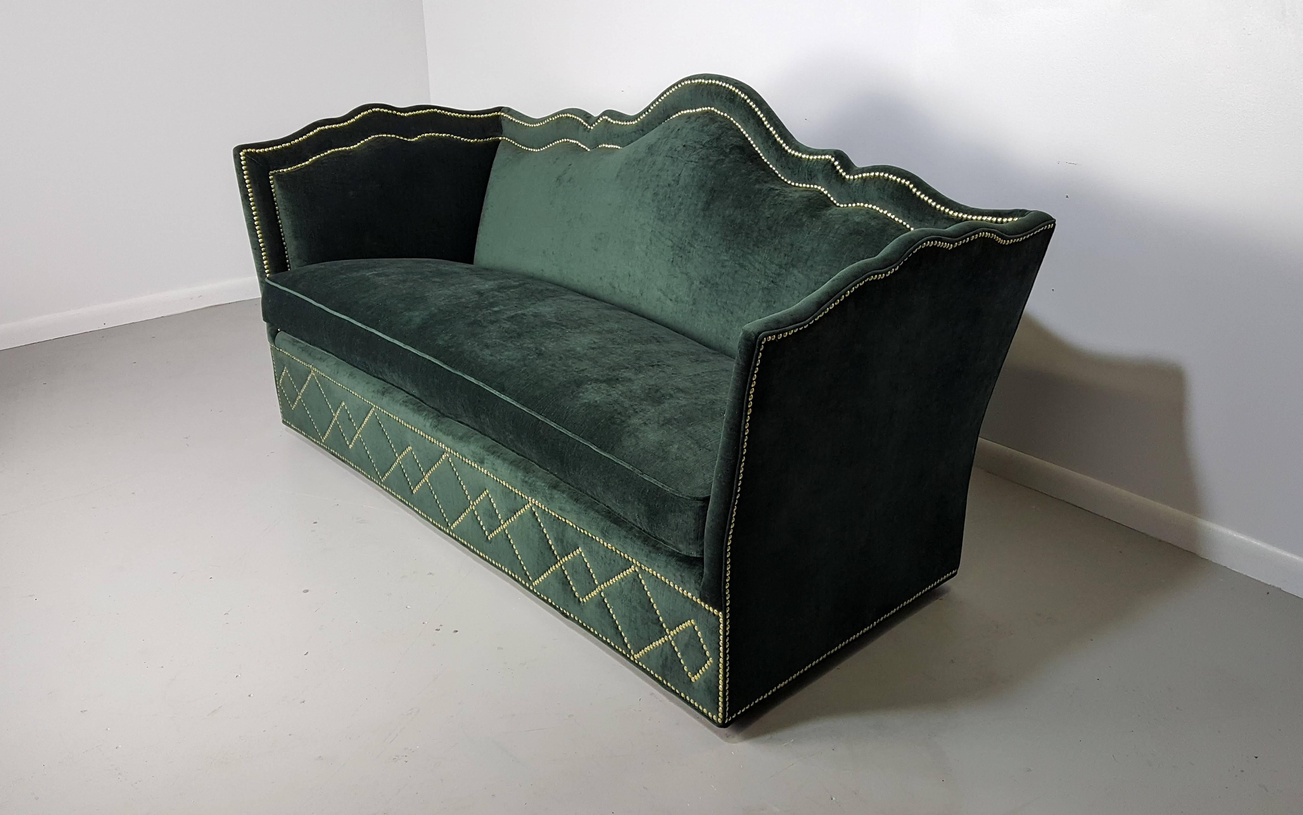 Incredibly luxurious sofa with nailhead detail by Baker Furniture, 1960s. Such a delightful Hollywood Regency piece. Very comfortable and of the highest quality. Newly refinished and in excellent condition.

See this item in our private NYC