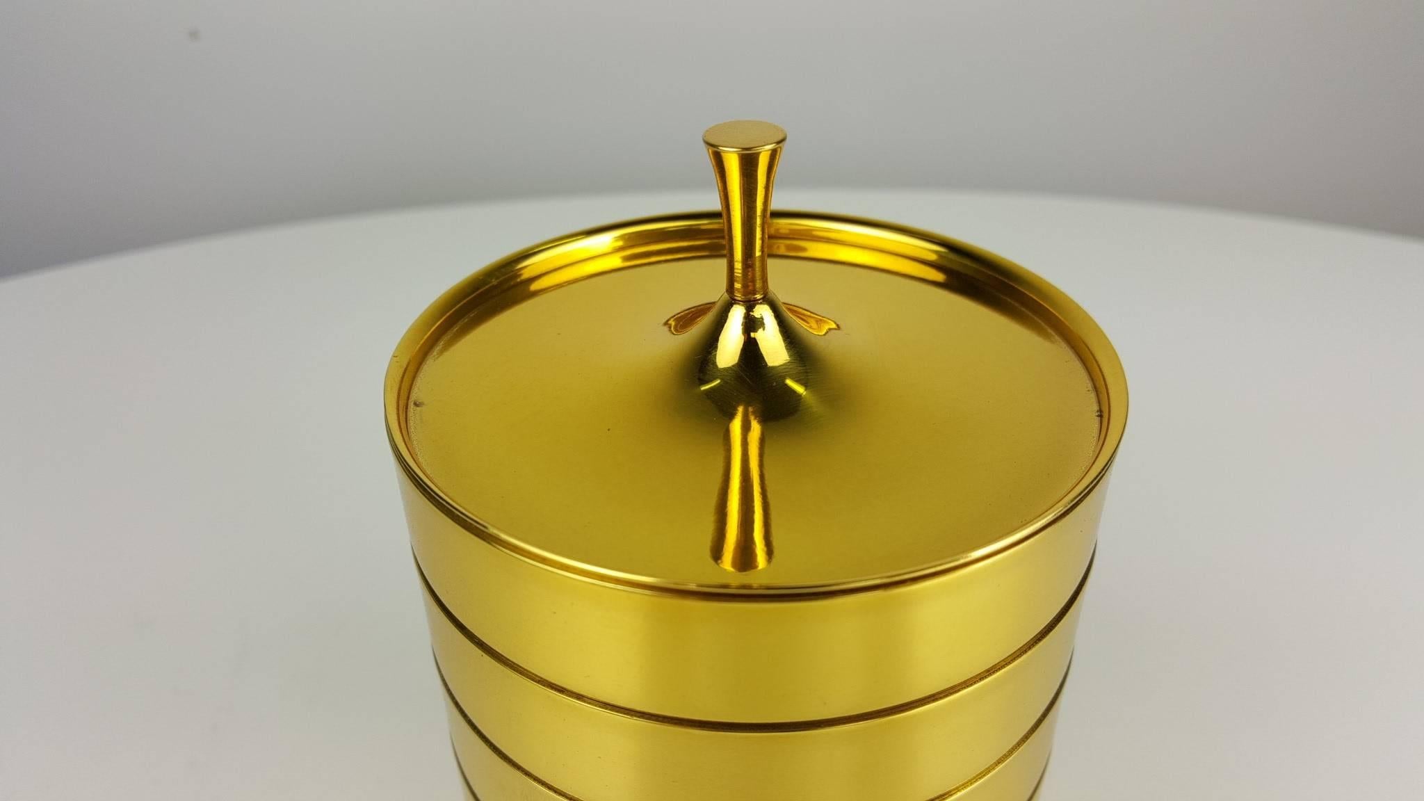 Rare set of brass drink coasters by Tommi Parzinger for Dorlyn, 1950s. The set consists of six stacking coasters with a decorative lid. These have been fully restored with a gold-toned brass finish. All pieces are stamped 