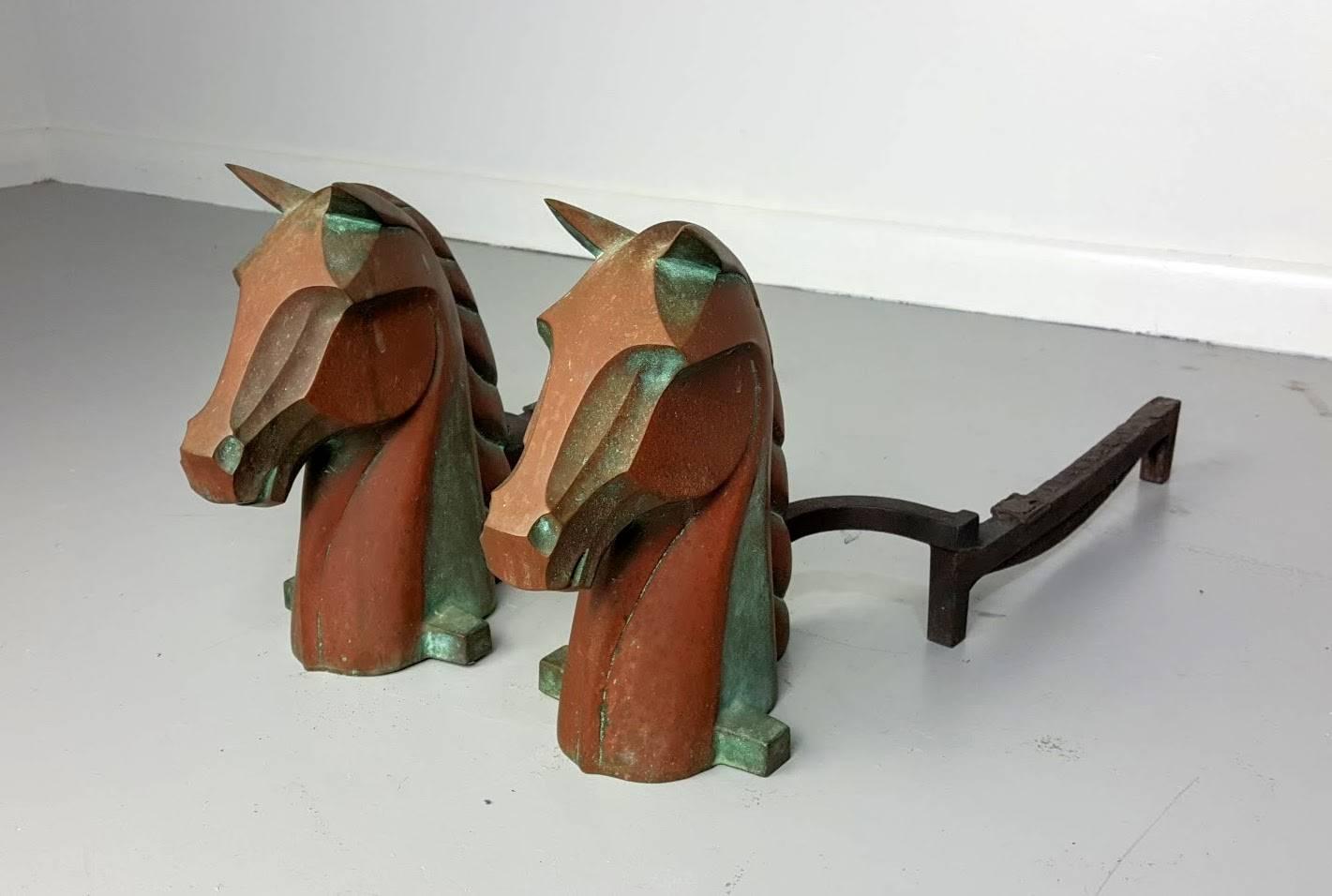 Equestrian horse head andirons in cast bronze by Reynolds Jones. Deco inspired. Heavily patina. 

See this item in our private NYC showroom! Refine Limited is located in the heart of Chelsea at the history Starrett-LeHigh Building, 601 West 26th