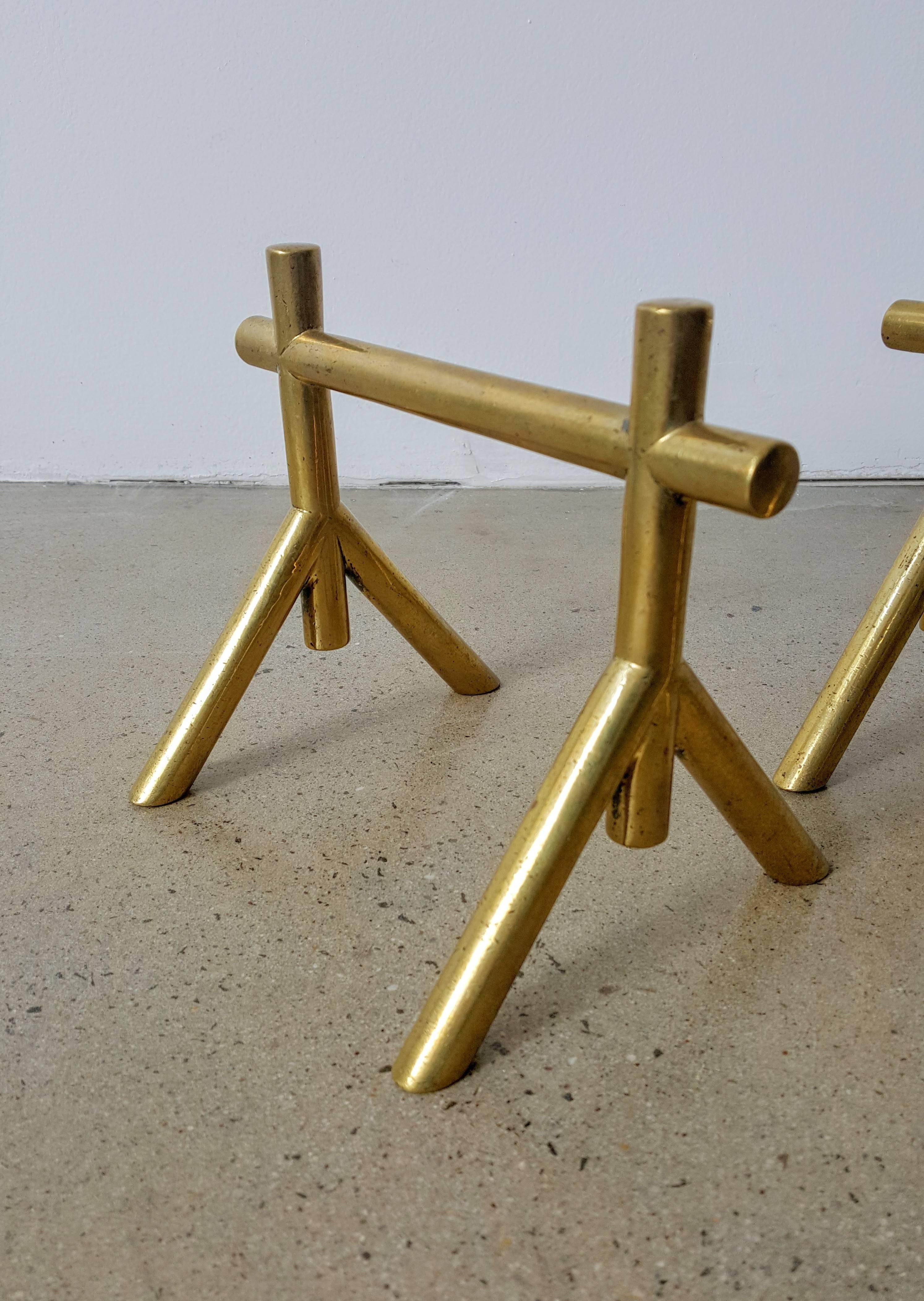 Elegant, sculptural solid brass andirons or fire dogs attributed to Christopher Dresser for Benham & Froud, England, circa 1900. Fabulous modern design that was way ahead of it's time. They more resemble much later designs by Maison Charles, George