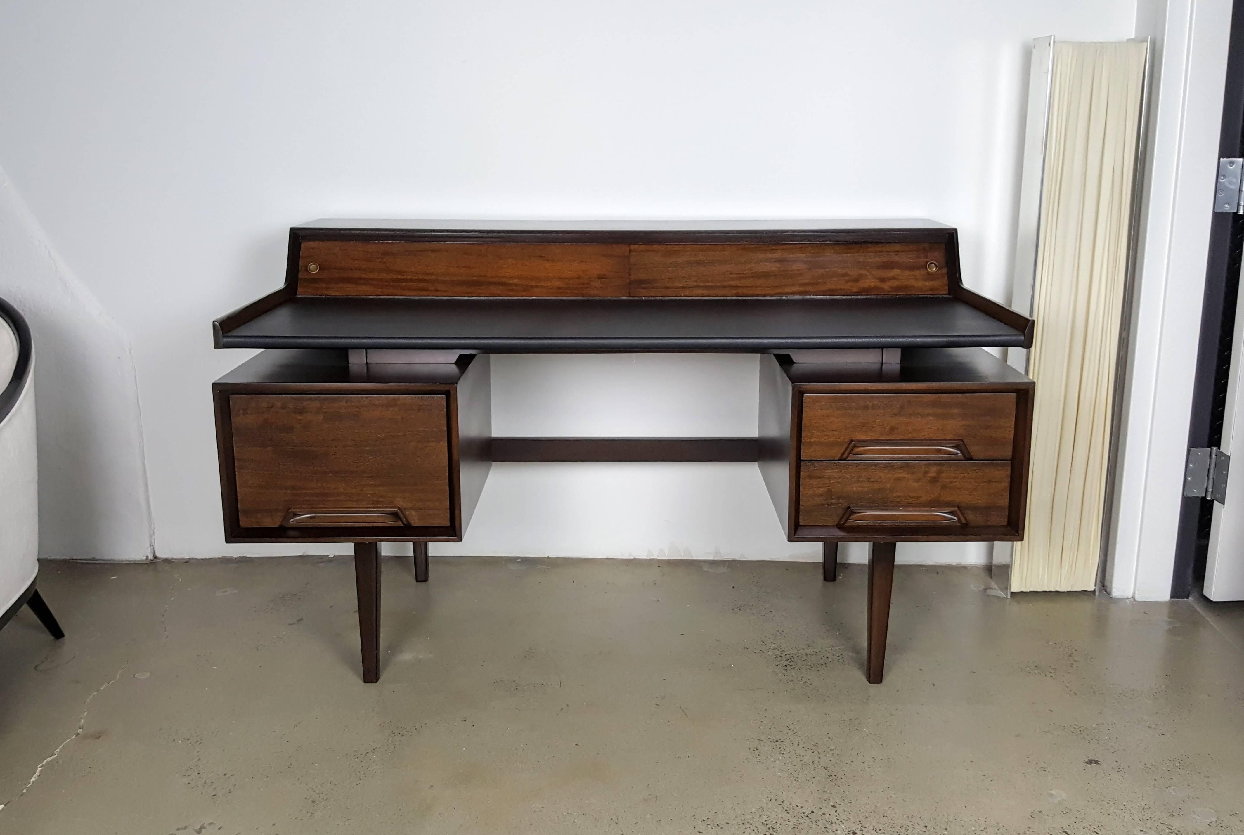 Architectural mahogany writing desk by Milo Baughman, 1960s. Beautiful design with great storage. Newly refinished with leather top.

See this item in our private NYC showroom! Refine Limited is located in the heart of Chelsea at the history