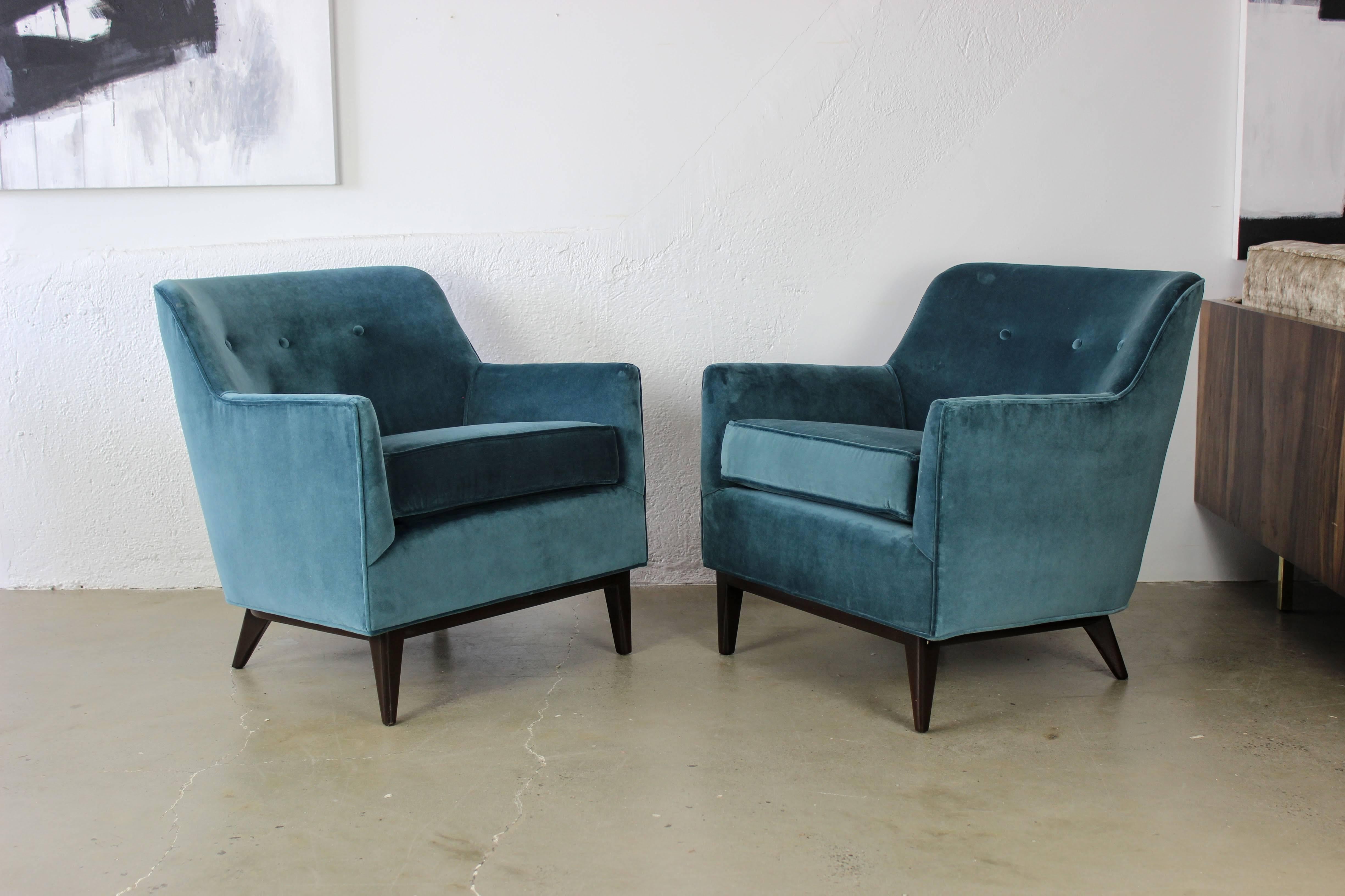 Handsome Mid-Century lounge chairs newly upholstered in a beautiful peacock velvet, 1950s. Bases are a dark walnut finish. Maker is unknown but they are similar to the designs of Milo Baughman, Harvey Probber, and Paul McCobb. Excellent weight and